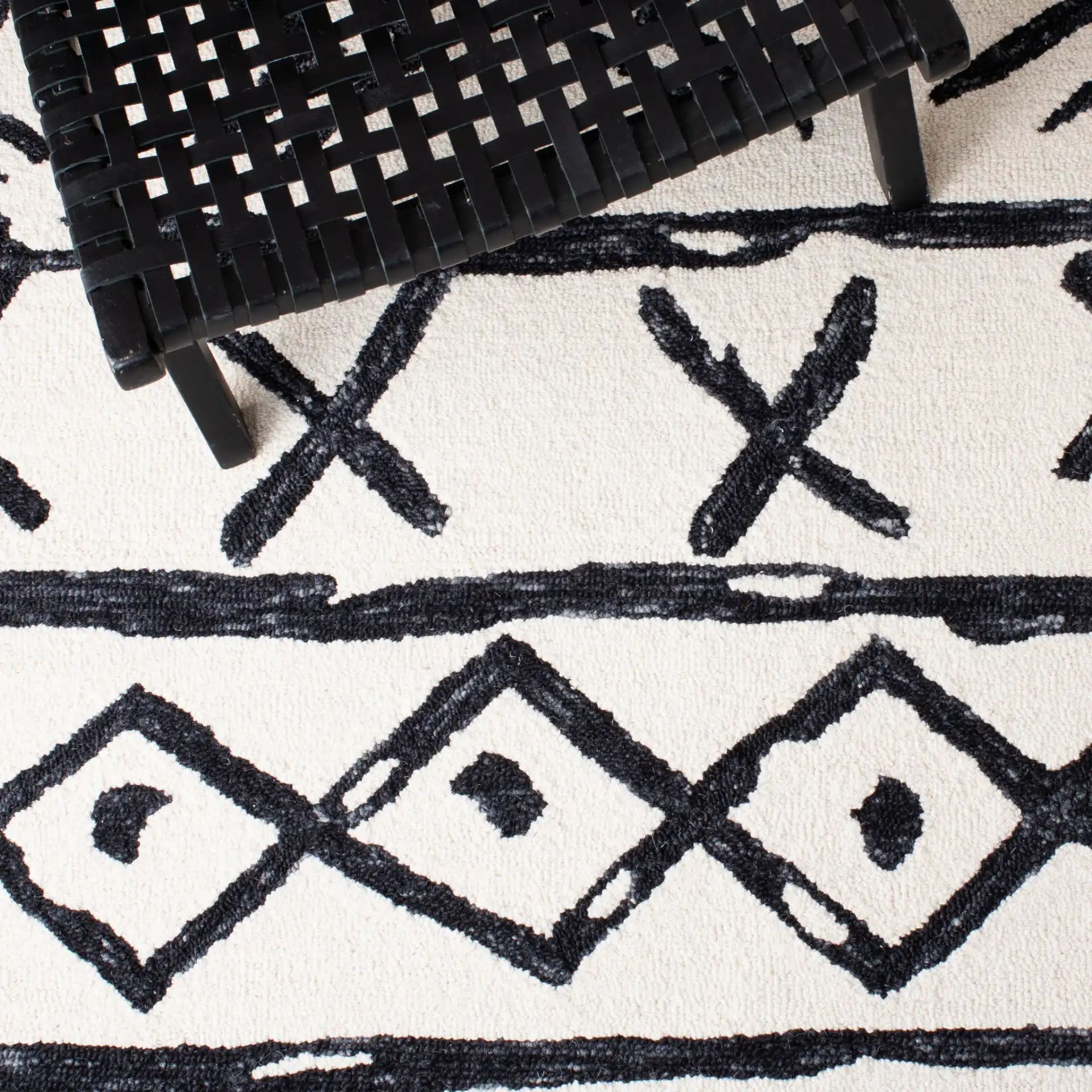 Metro Tribal Motif Stripe Hand-Tufted Wool Rug in Black / Ivory in a styled room