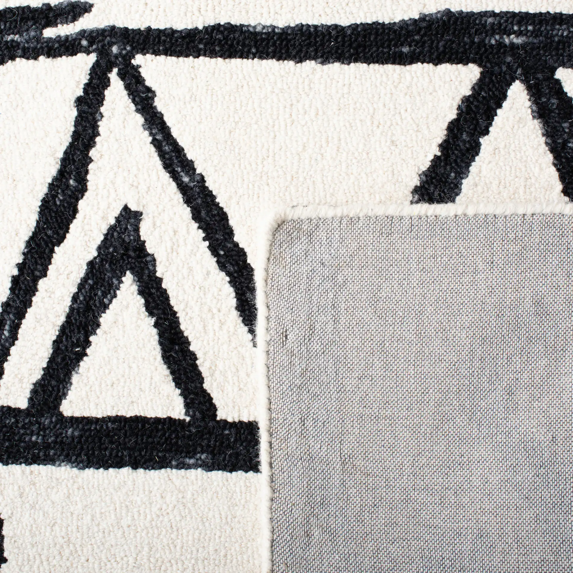 Metro Tribal Motif Stripe Hand-Tufted Wool Rug in Black / Ivory in a styled room