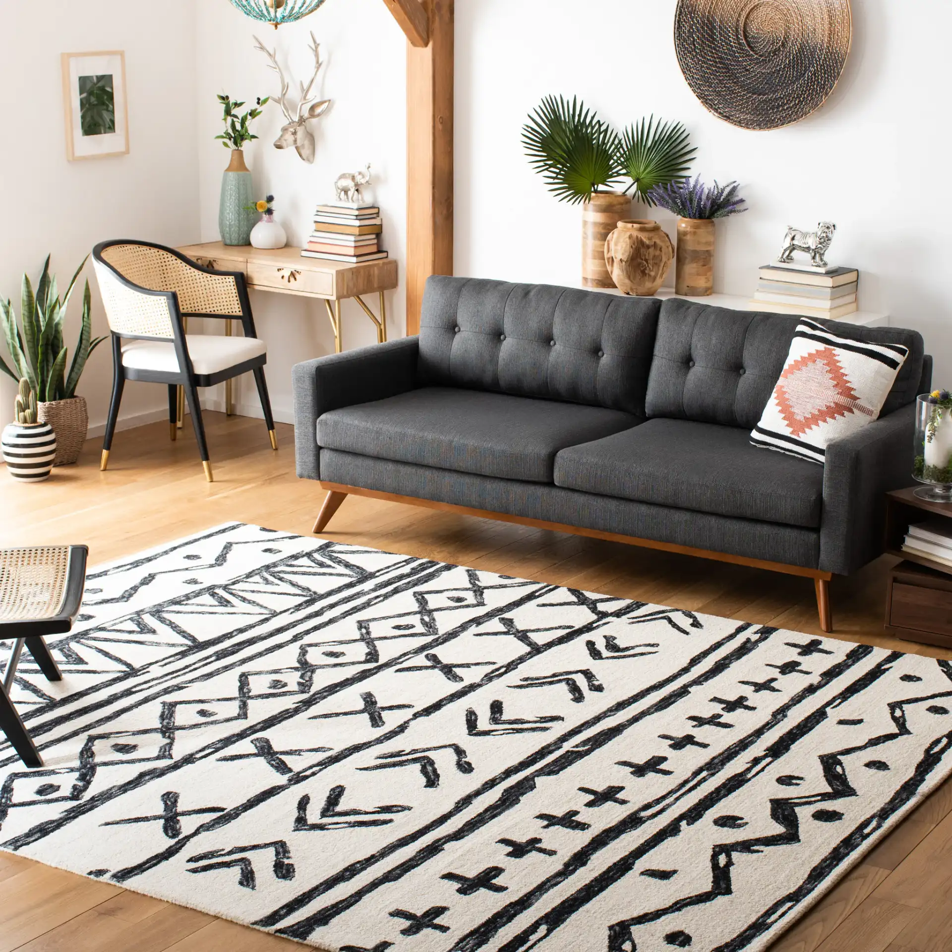 Metro Tribal Motif Stripe Hand-Tufted Wool Rug in Black / Ivory in a styled room