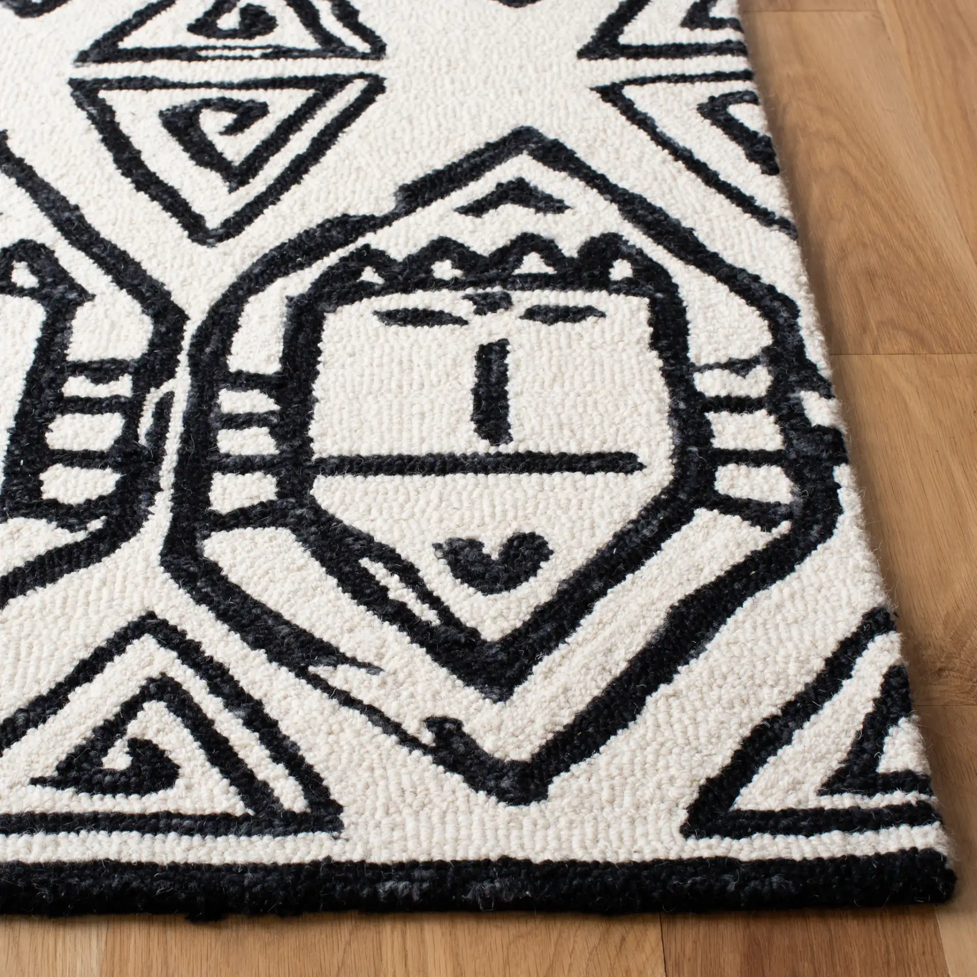 Metro Tribal Mask Hand-Tufted Wool Rug in Black / Ivory in a styled room