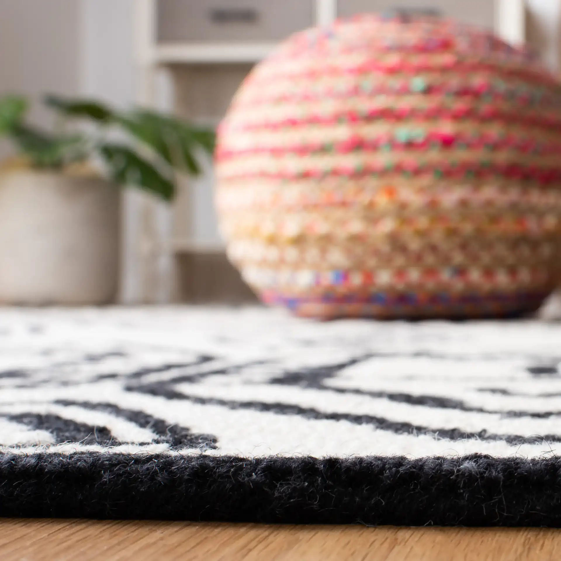 Metro Tribal Mask Hand-Tufted Wool Rug in Black / Ivory in a styled room