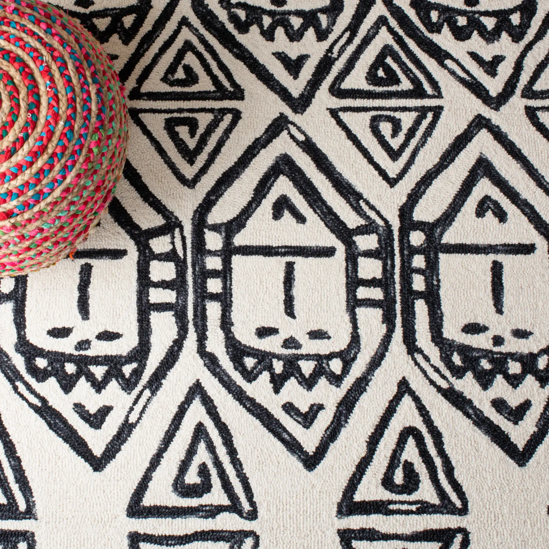 Metro Tribal Mask Hand-Tufted Wool Rug in Black / Ivory in a styled room