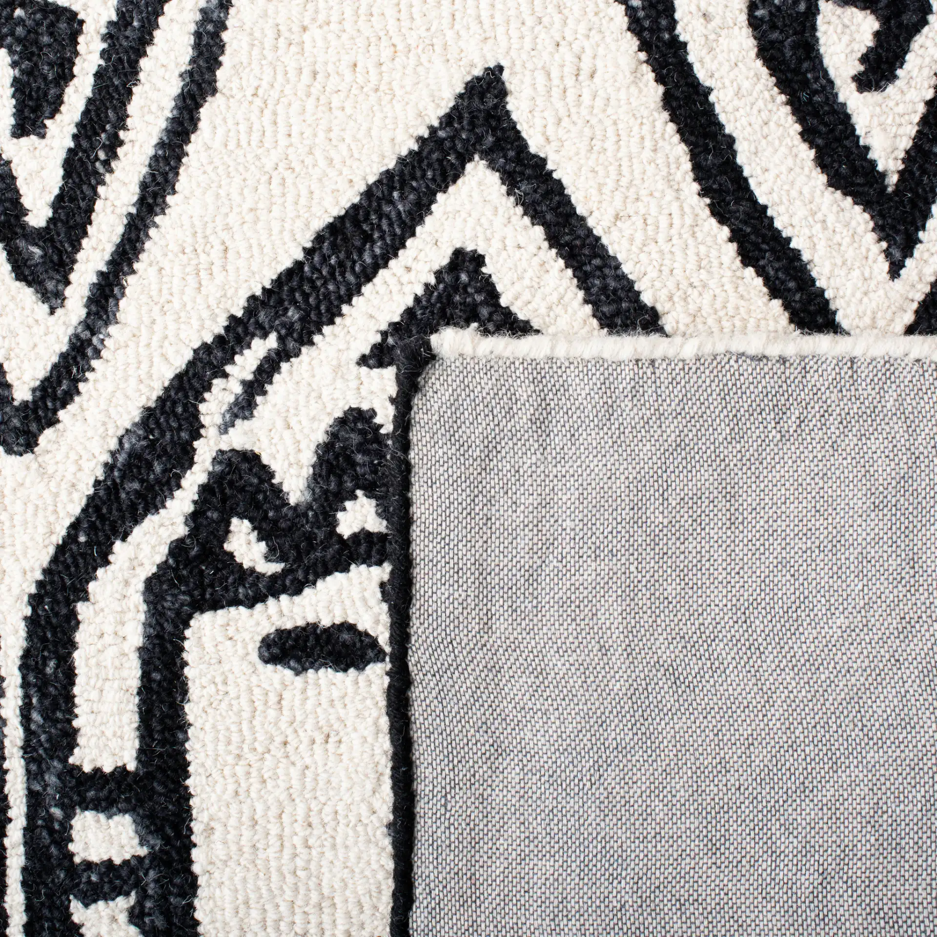 Metro Tribal Mask Hand-Tufted Wool Rug in Black / Ivory in a styled room
