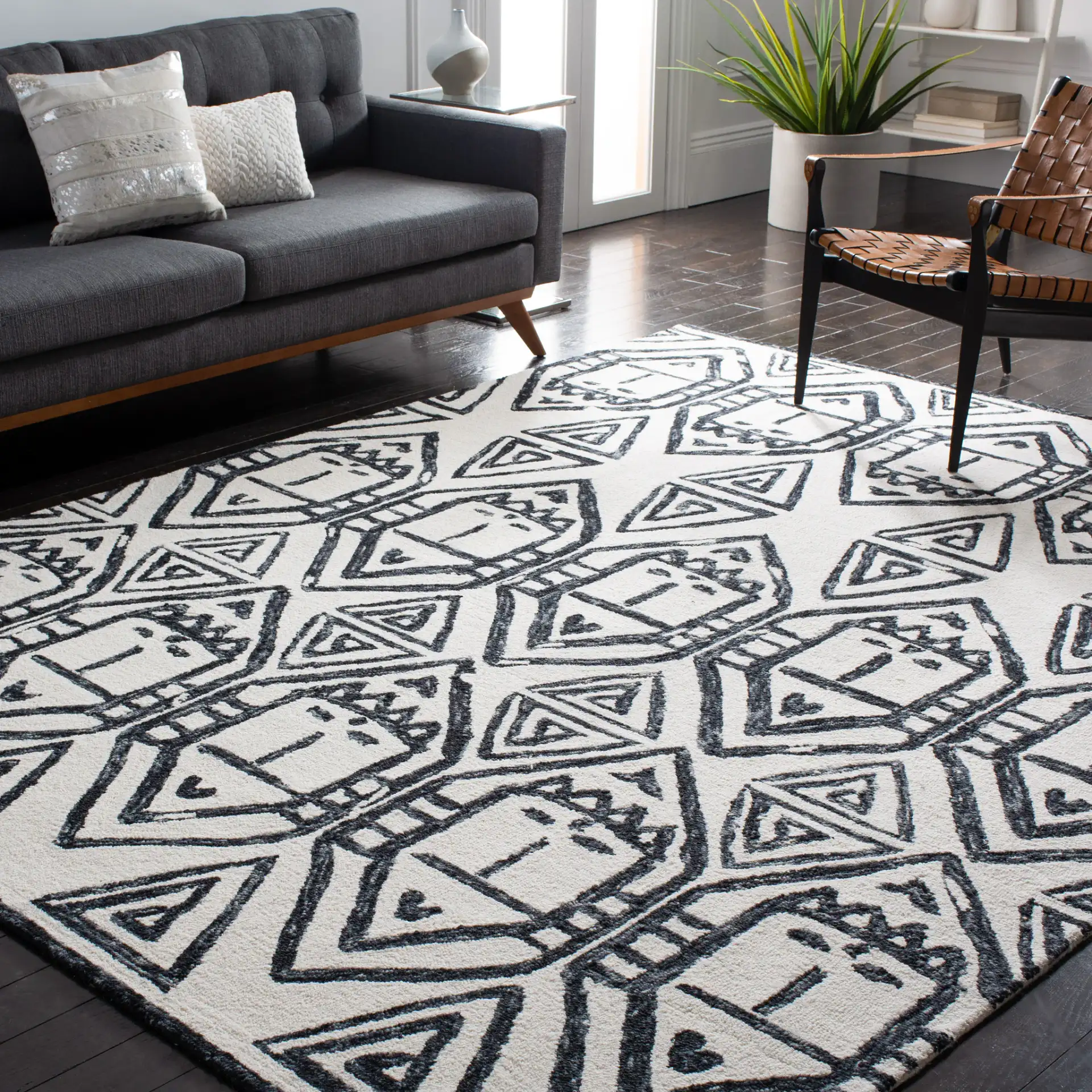 Metro Tribal Mask Hand-Tufted Wool Rug in Black / Ivory in a styled room