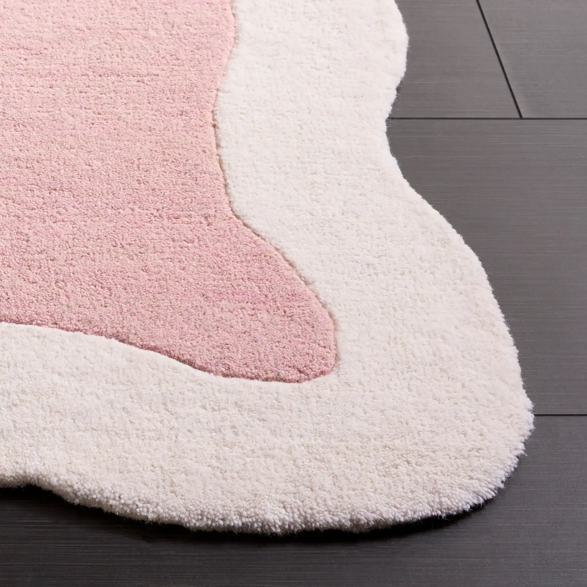 Metro Modern Scalloped Border Hand-Tufted Wool Rug in Pink / Ivory in a styled room