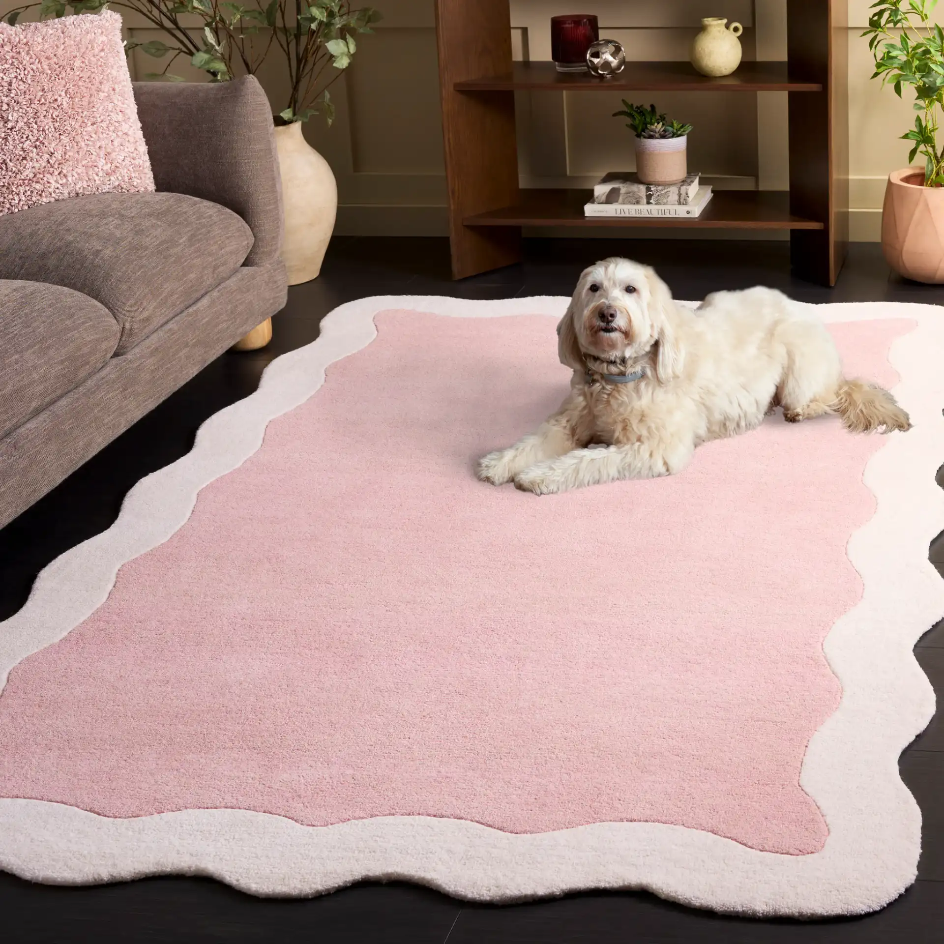 Metro Modern Scalloped Border Hand-Tufted Wool Rug in Pink / Ivory in a styled room
