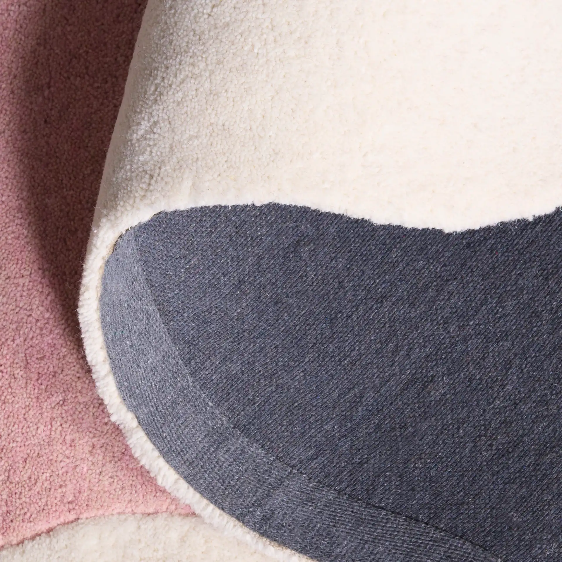 Metro Modern Scalloped Border Hand-Tufted Wool Rug in Pink / Ivory in a styled room