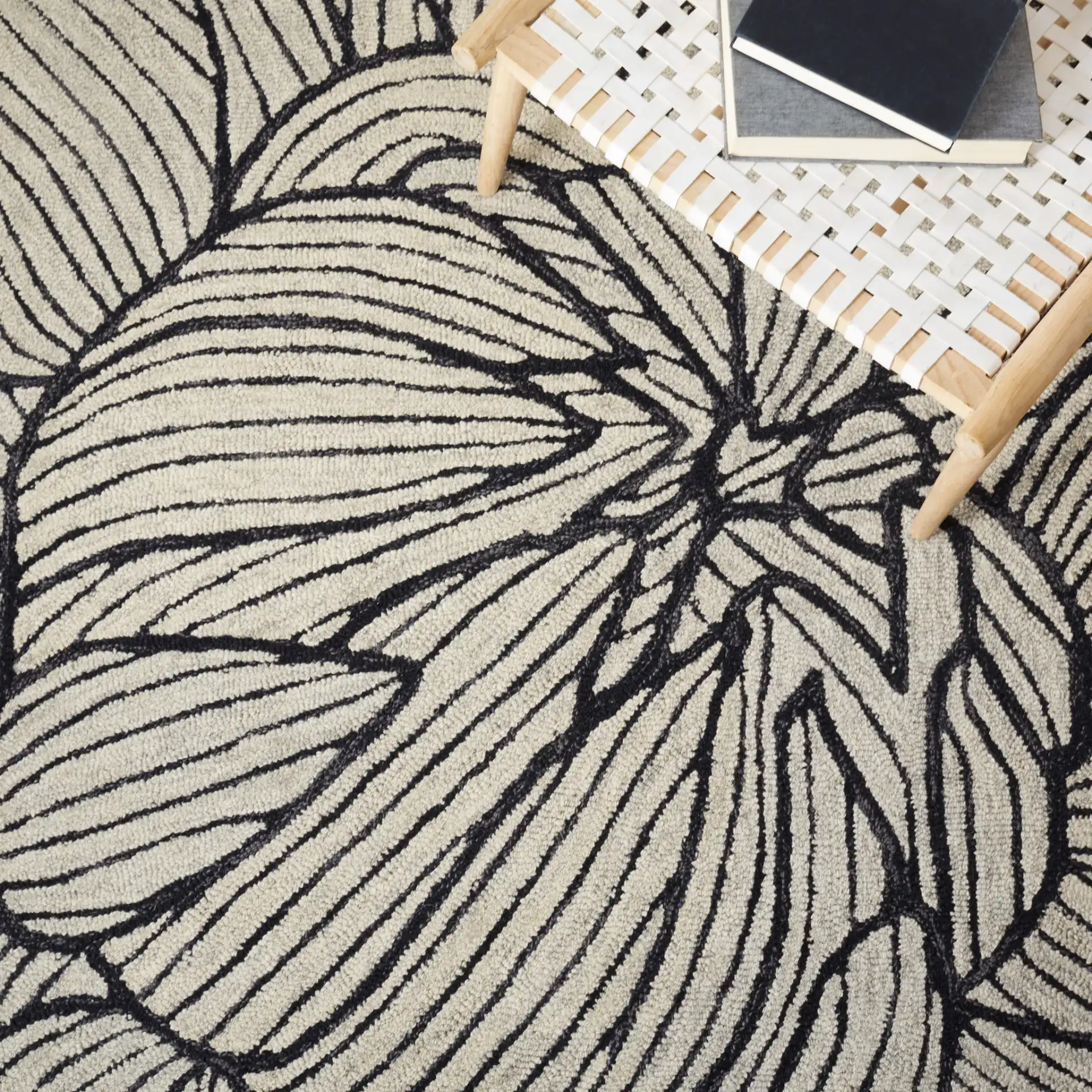 Metro Blooming Flower Hand-Tufted Wool Rug in Black / Ivory in a styled room