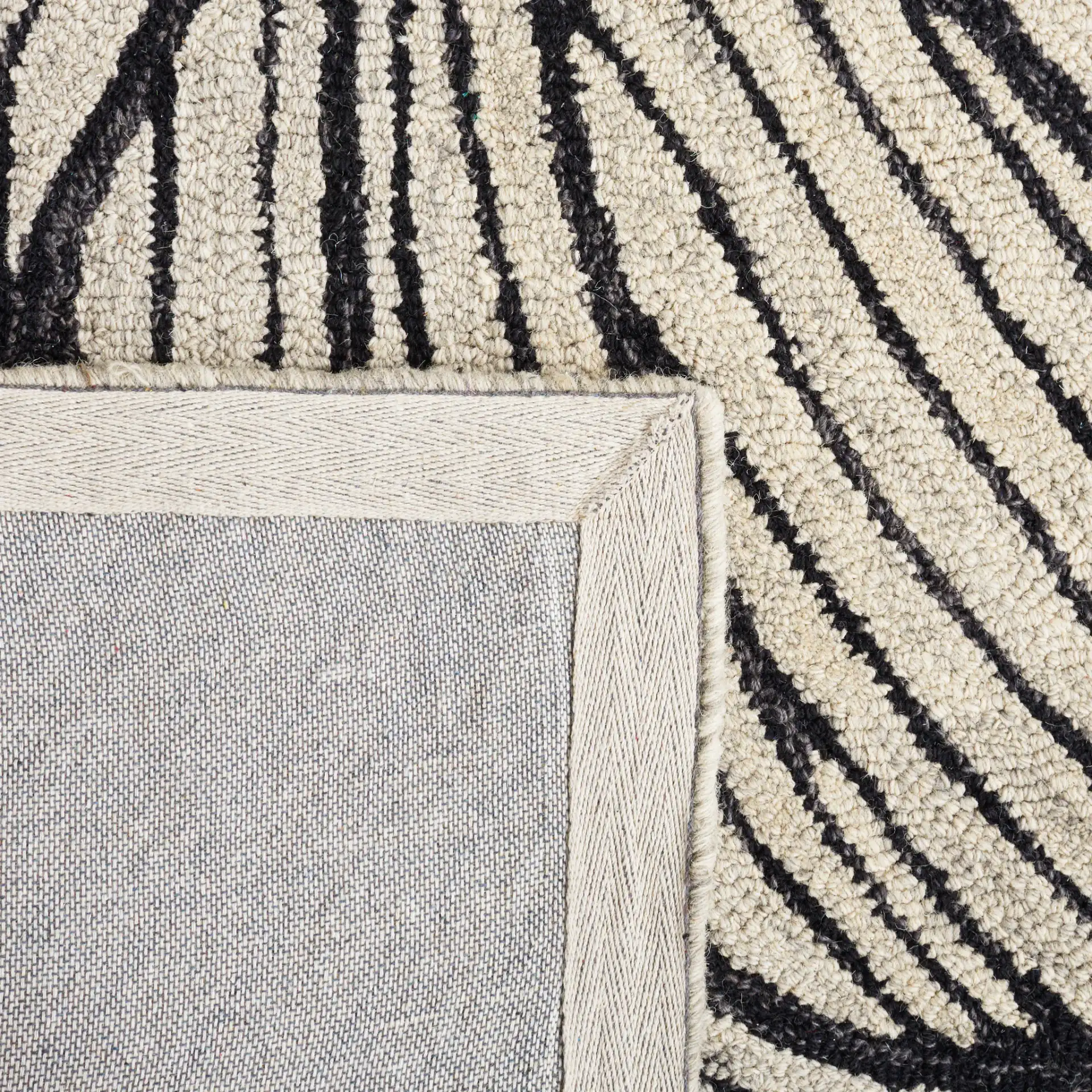 Metro Blooming Flower Hand-Tufted Wool Rug in Black / Ivory in a styled room