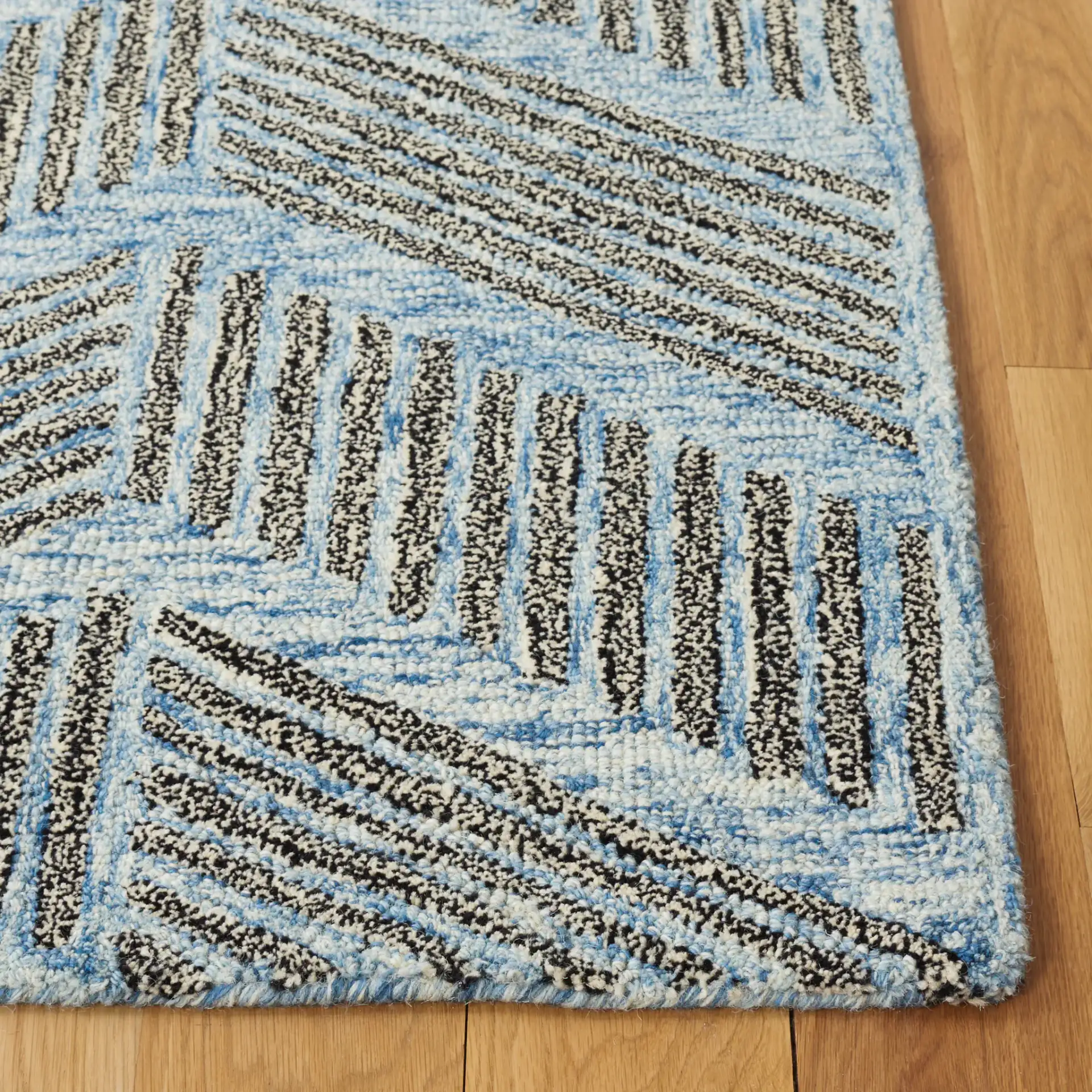 Metro Modern Chevron Hand-Tufted Wool Rug in Blue / Black in a styled room