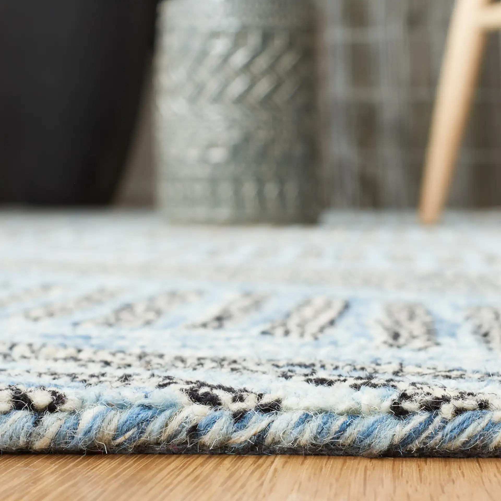 Metro Modern Chevron Hand-Tufted Wool Rug in Blue / Black in a styled room