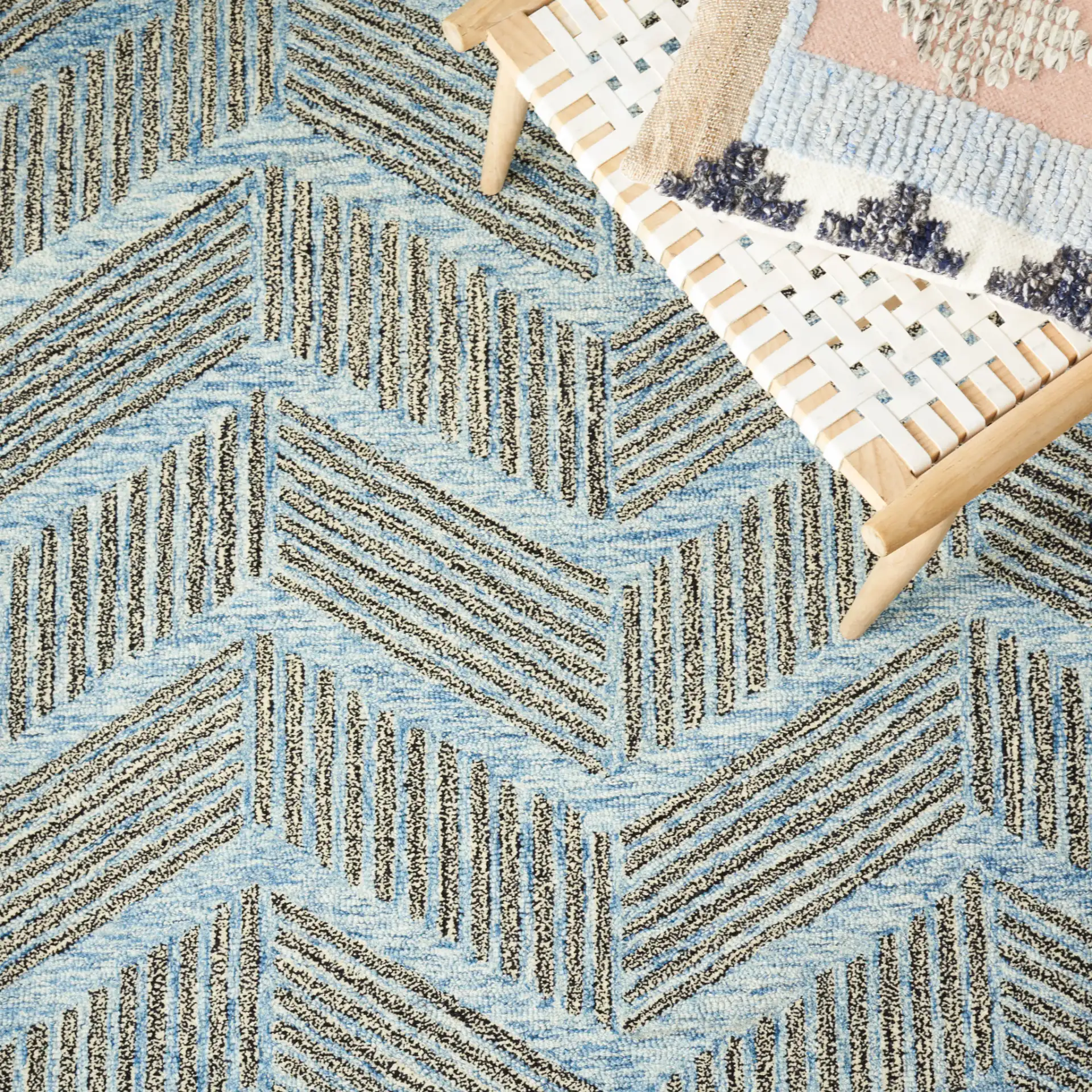 Metro Modern Chevron Hand-Tufted Wool Rug in Blue / Black in a styled room