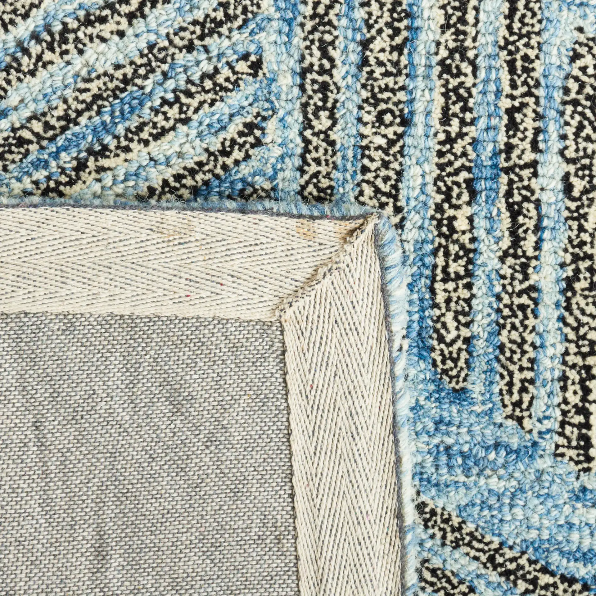 Metro Modern Chevron Hand-Tufted Wool Rug in Blue / Black in a styled room