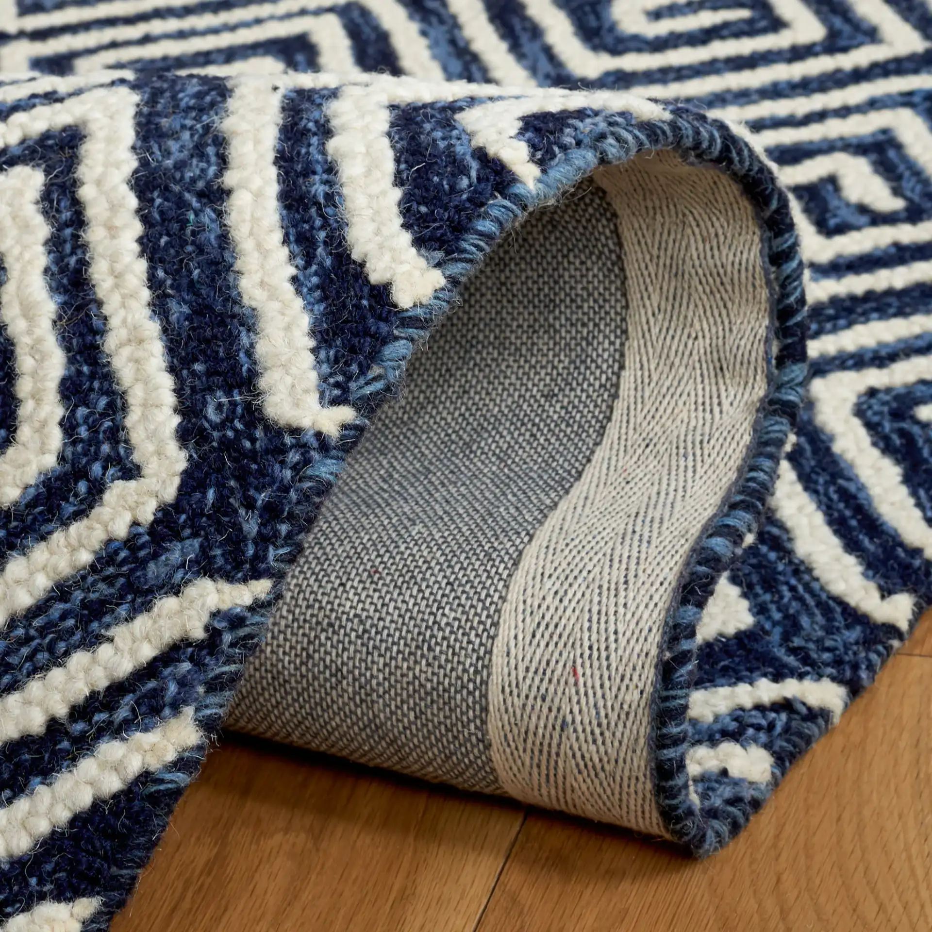 Metro Maze Hand-Tufted Wool Rug in Navy / Ivory in a styled room