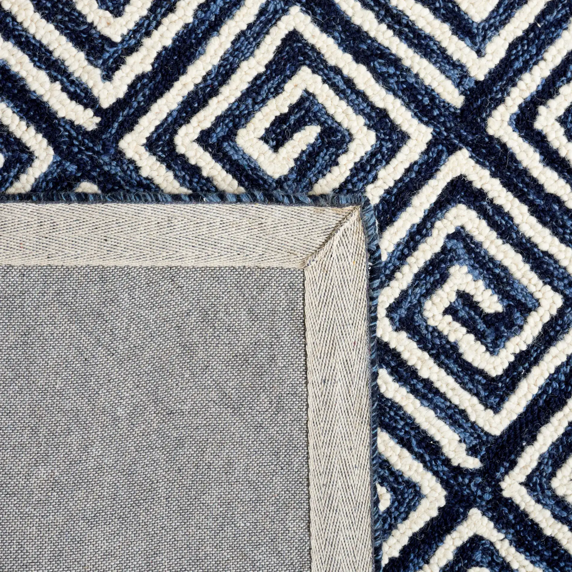 Metro Maze Hand-Tufted Wool Rug in Navy / Ivory in a styled room