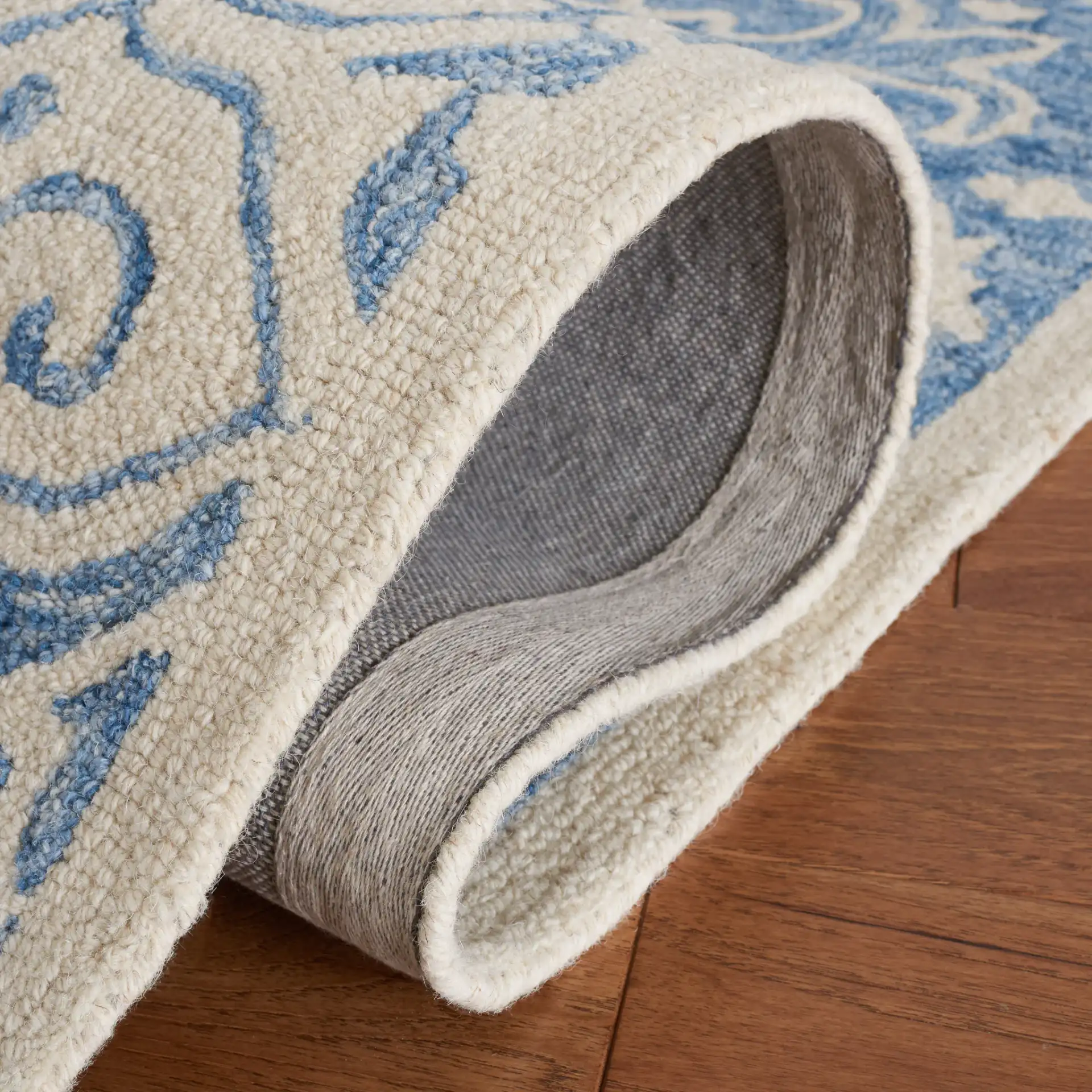 Metro Geometric Medallion Hand-Tufted Wool Rug in Blue / Ivory in a styled room