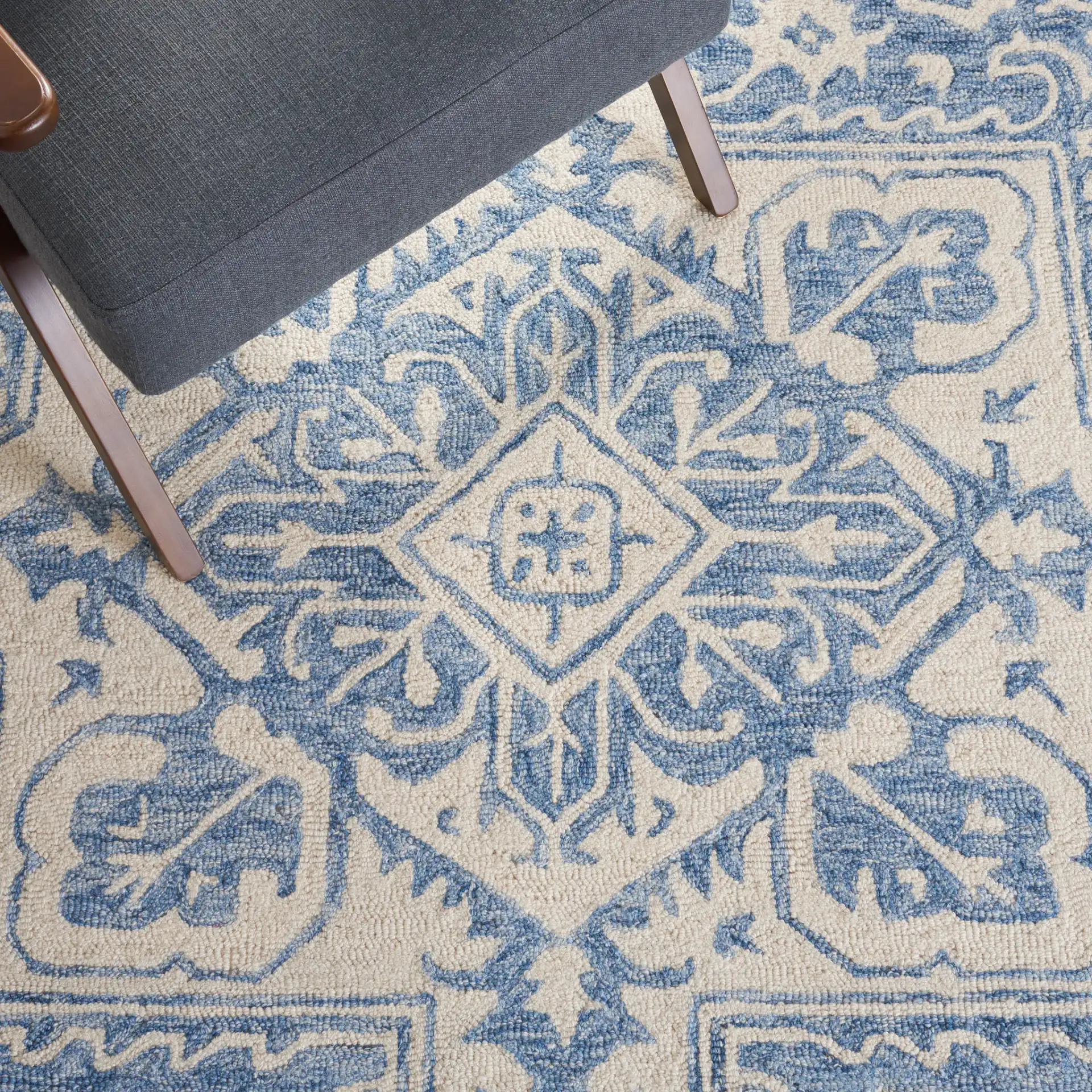 Metro Geometric Medallion Hand-Tufted Wool Rug in Blue / Ivory in a styled room
