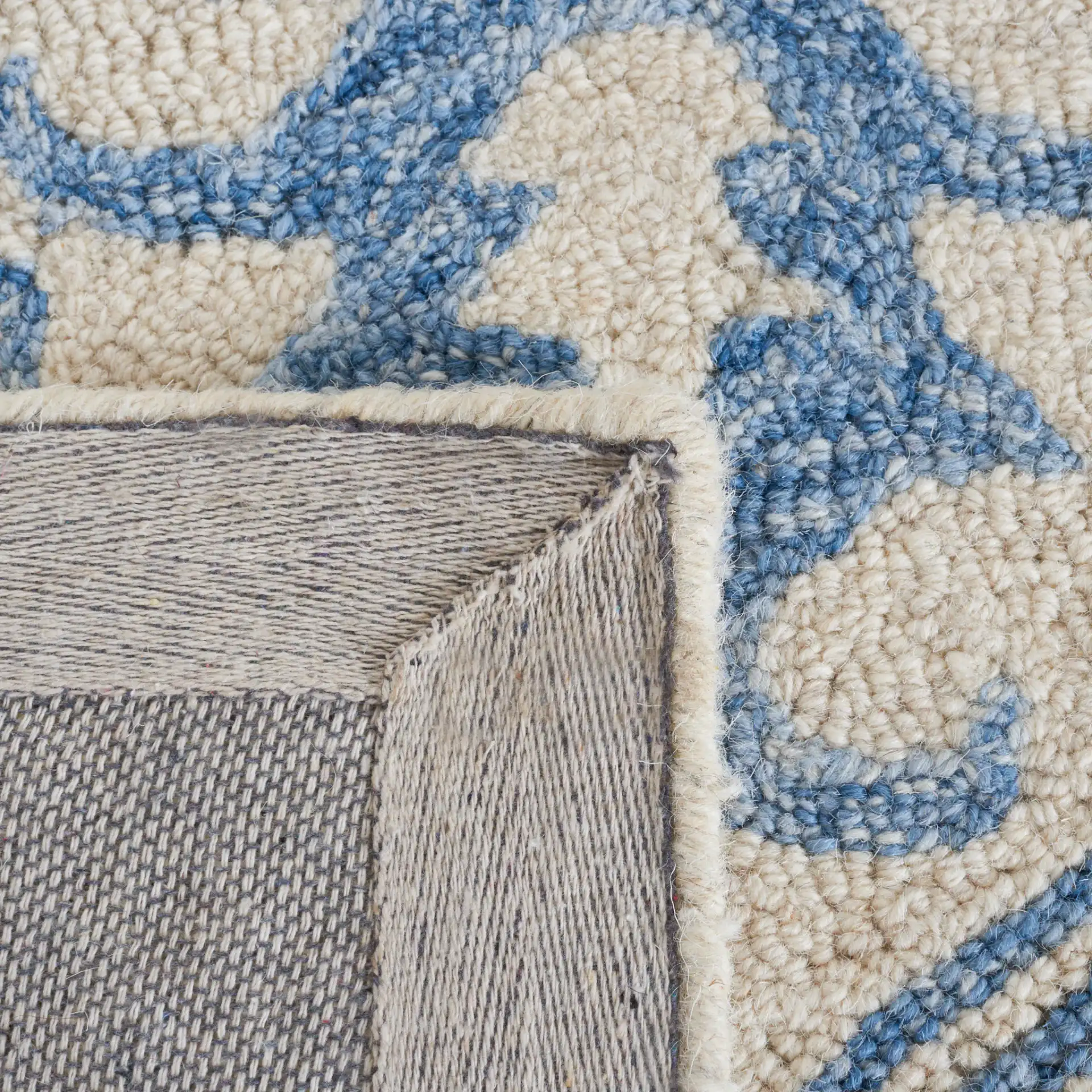 Metro Geometric Medallion Hand-Tufted Wool Rug in Blue / Ivory in a styled room