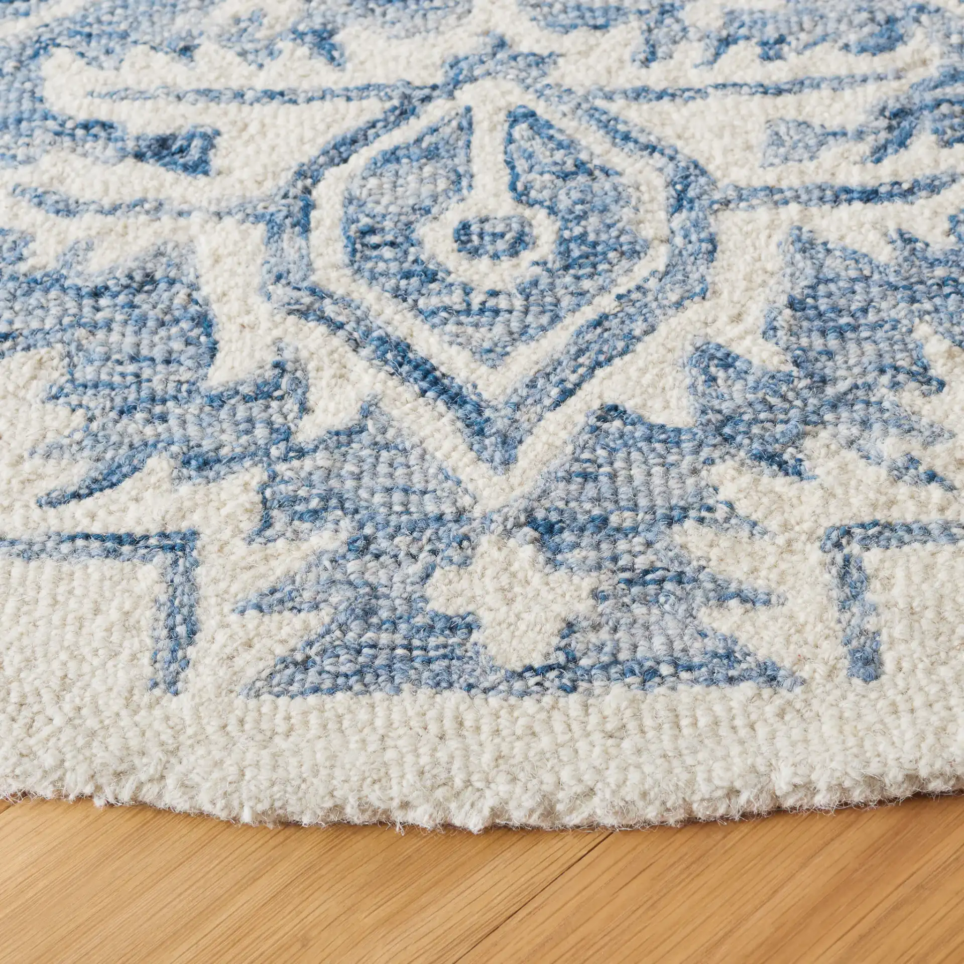 Metro Geometric Medallion Hand-Tufted Wool Rug in Blue / Ivory in a styled room