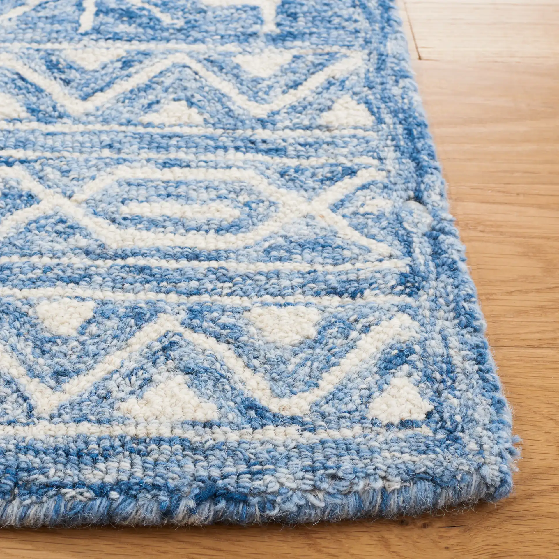 Metro Stepped Outline Diamond Hand-Tufted Wool Rug in Blue / Ivory in a styled room