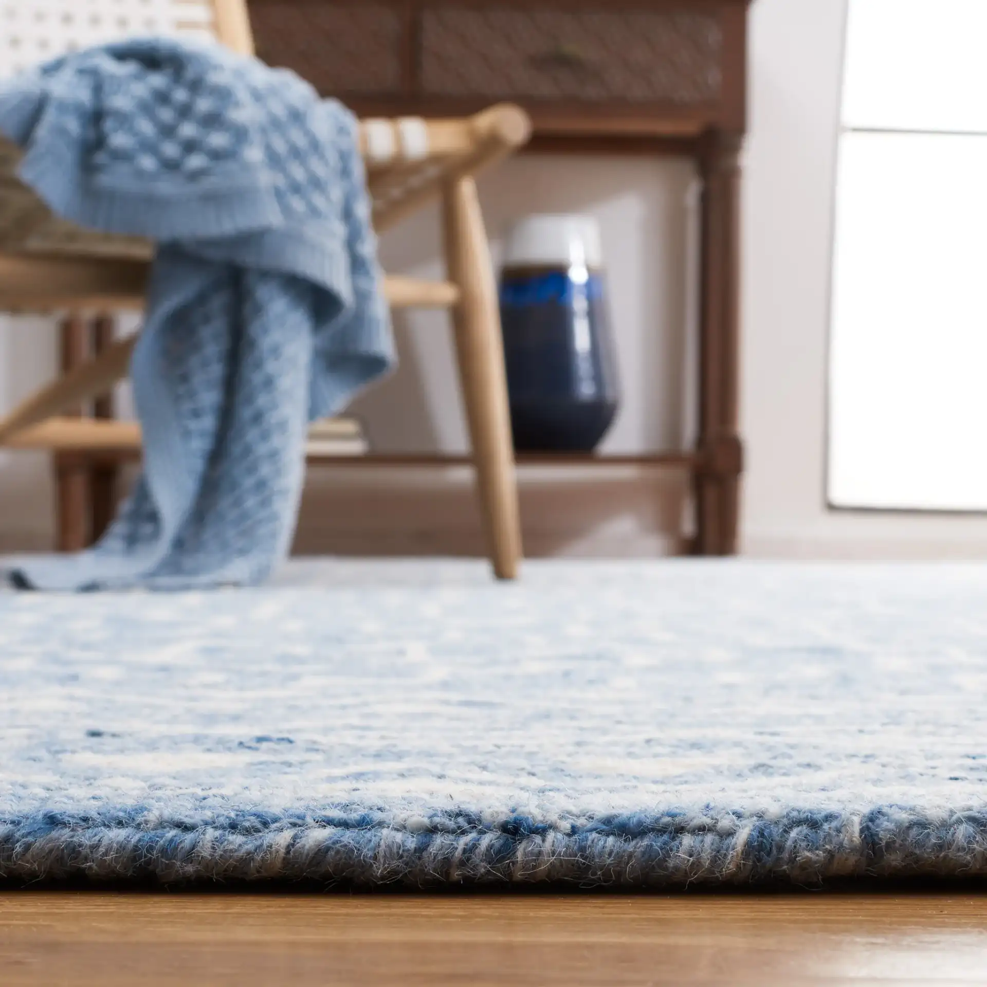 Metro Stepped Outline Diamond Hand-Tufted Wool Rug in Blue / Ivory in a styled room