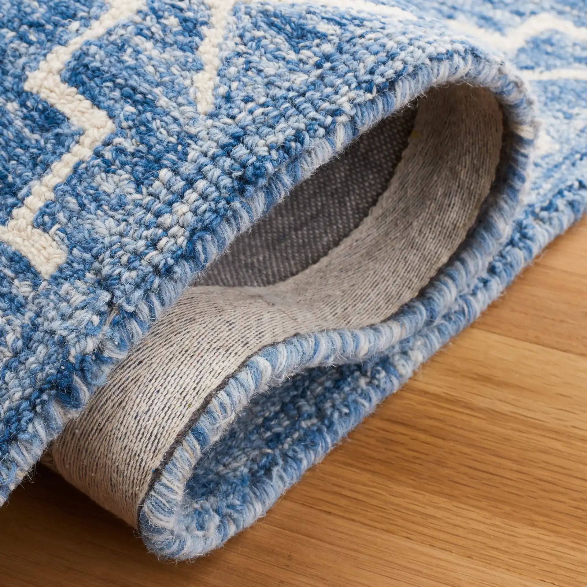 Metro Stepped Outline Diamond Hand-Tufted Wool Rug in Blue / Ivory in a styled room