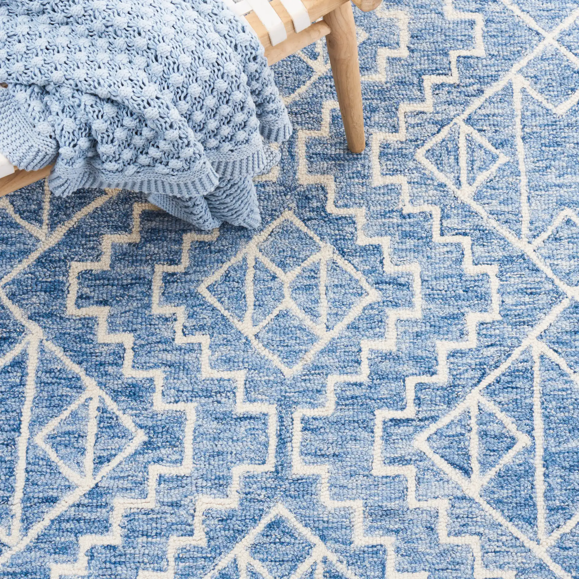Metro Stepped Outline Diamond Hand-Tufted Wool Rug in Blue / Ivory in a styled room