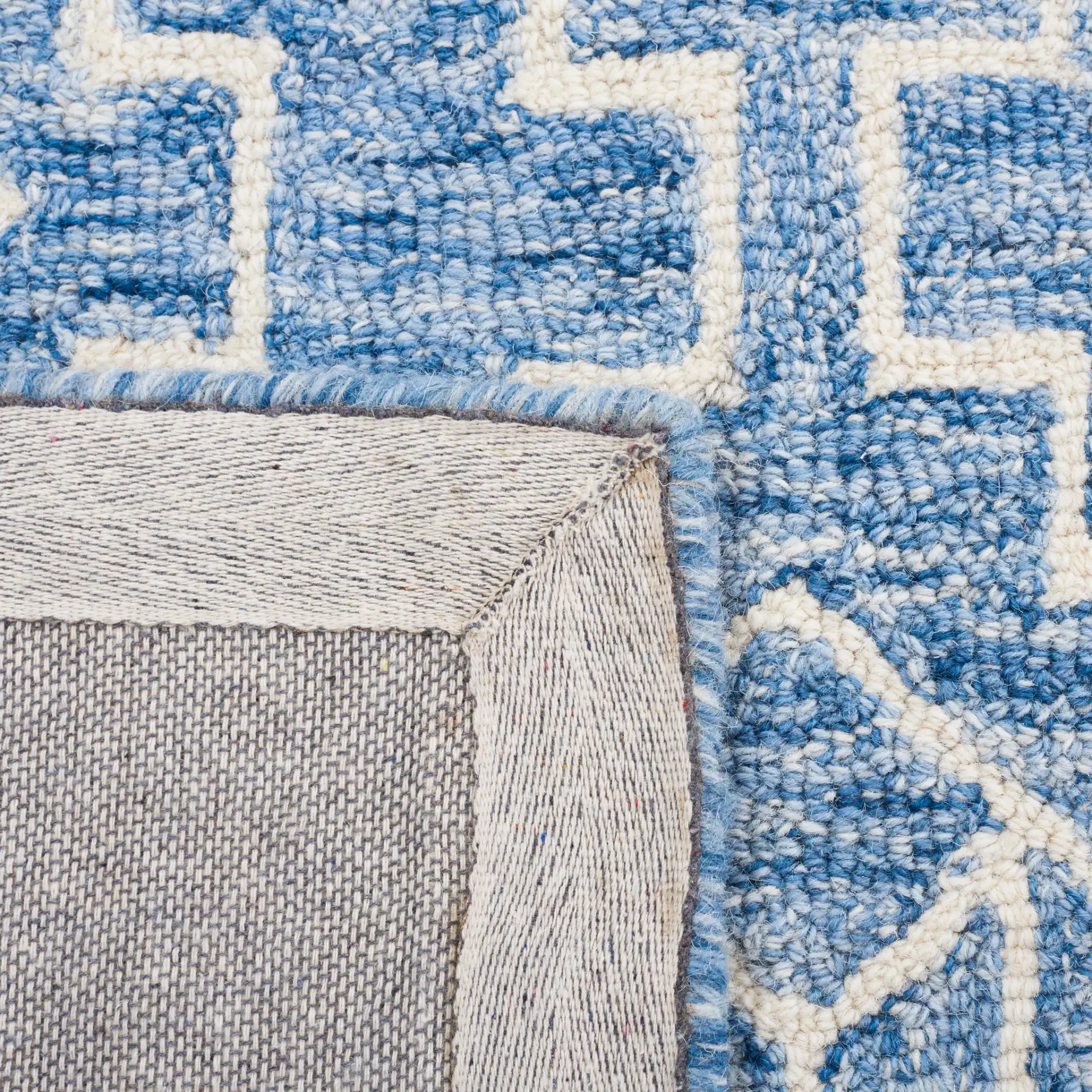 Metro Stepped Outline Diamond Hand-Tufted Wool Rug in Blue / Ivory in a styled room