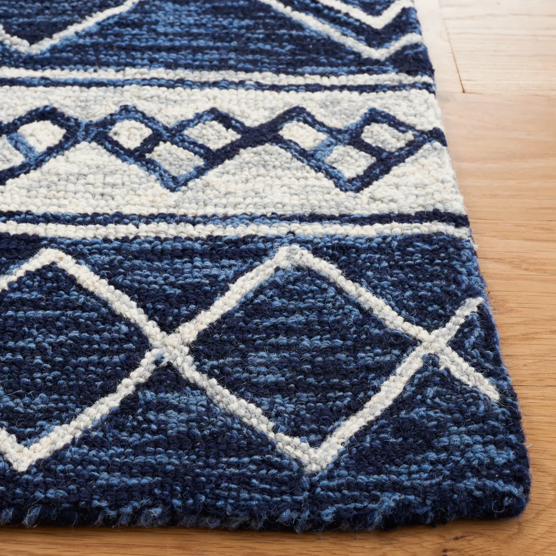 Metro Diamond Banded Hand-Tufted Wool Rug in Navy / Ivory in a styled room