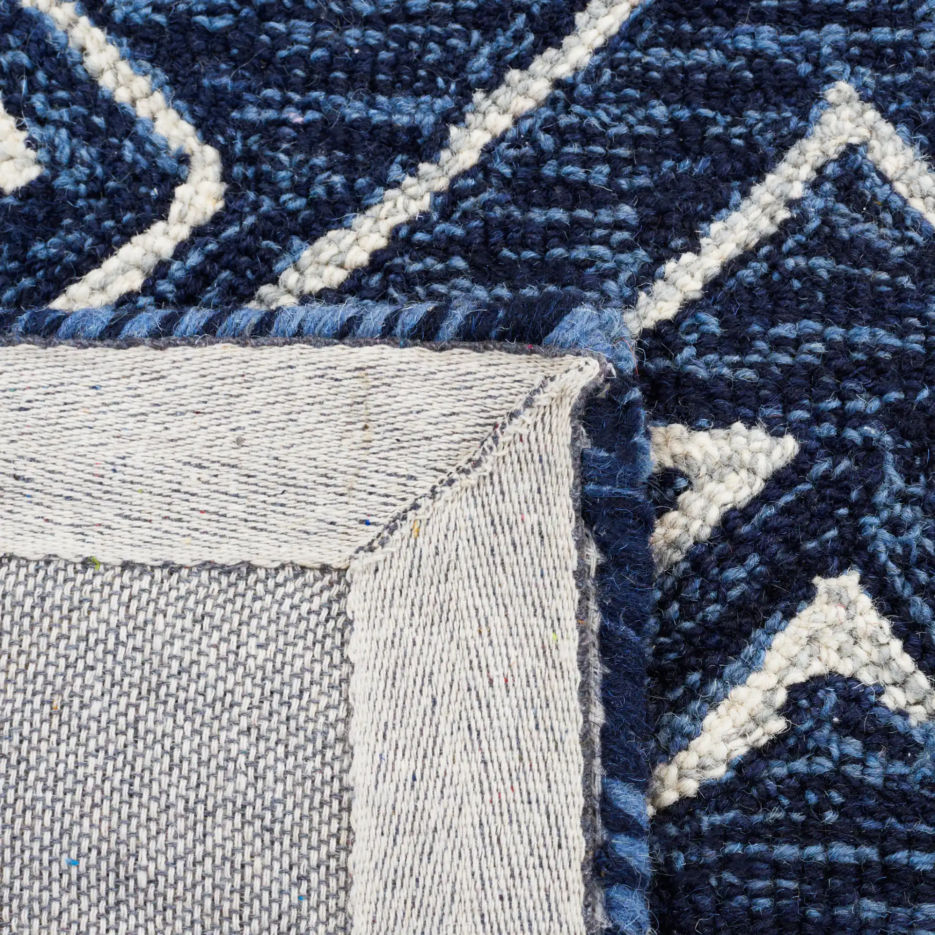 Metro Diamond Banded Hand-Tufted Wool Rug in Navy / Ivory in a styled room