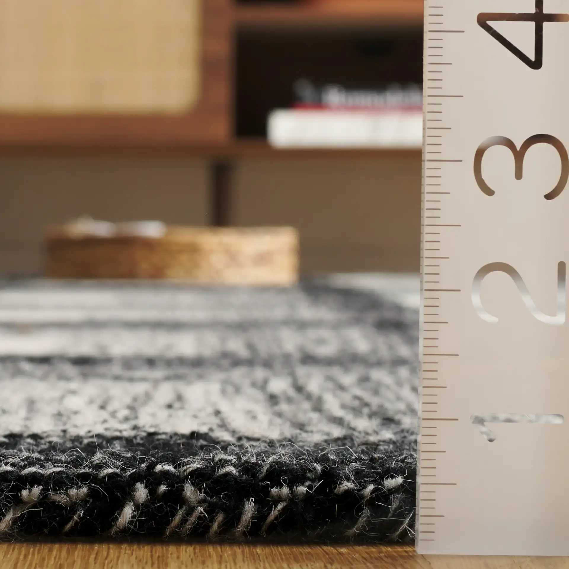 Metro Optical Grid Hand-Tufted Wool Rug in Charcoal / Ivory in a styled room