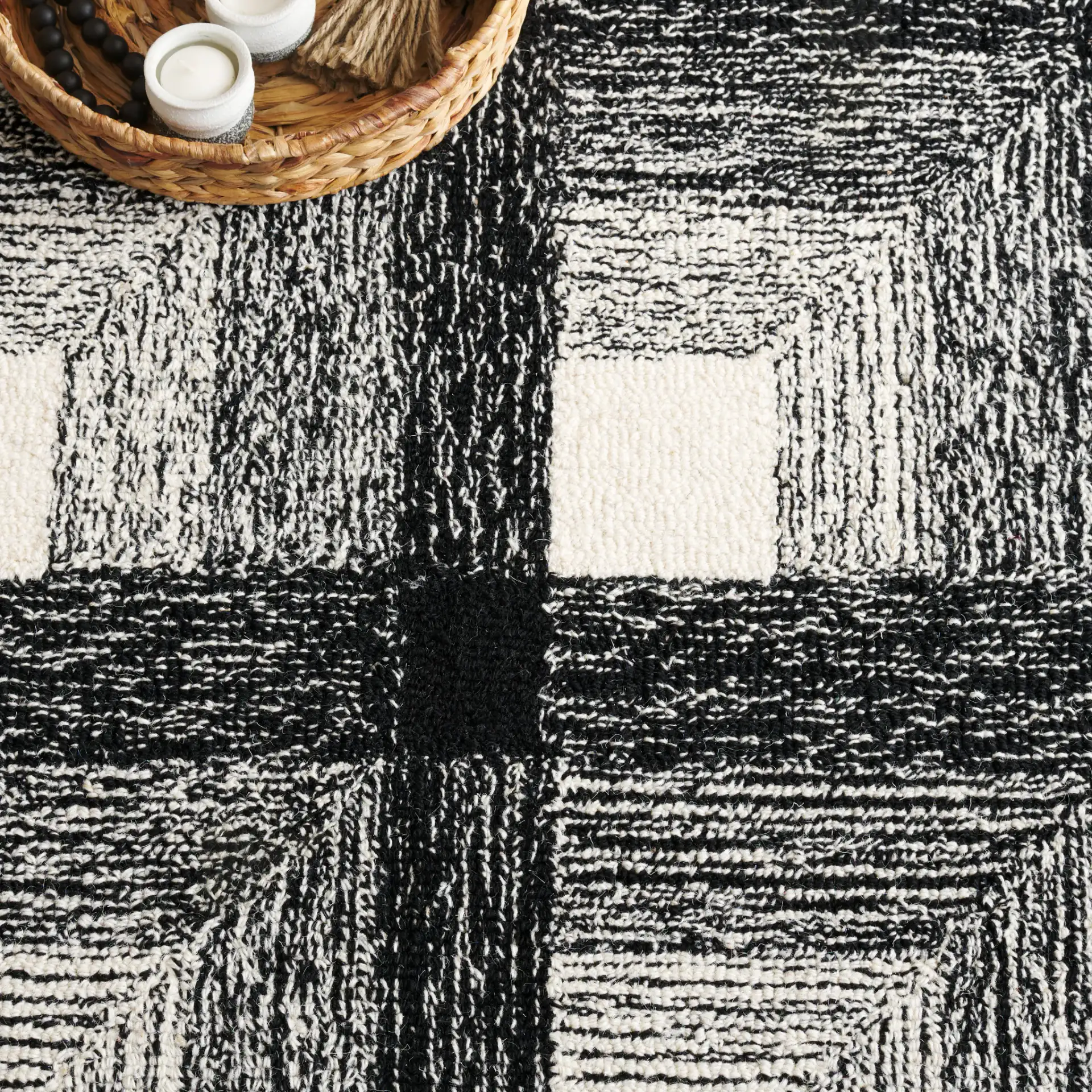 Metro Optical Grid Hand-Tufted Wool Rug in Charcoal / Ivory in a styled room