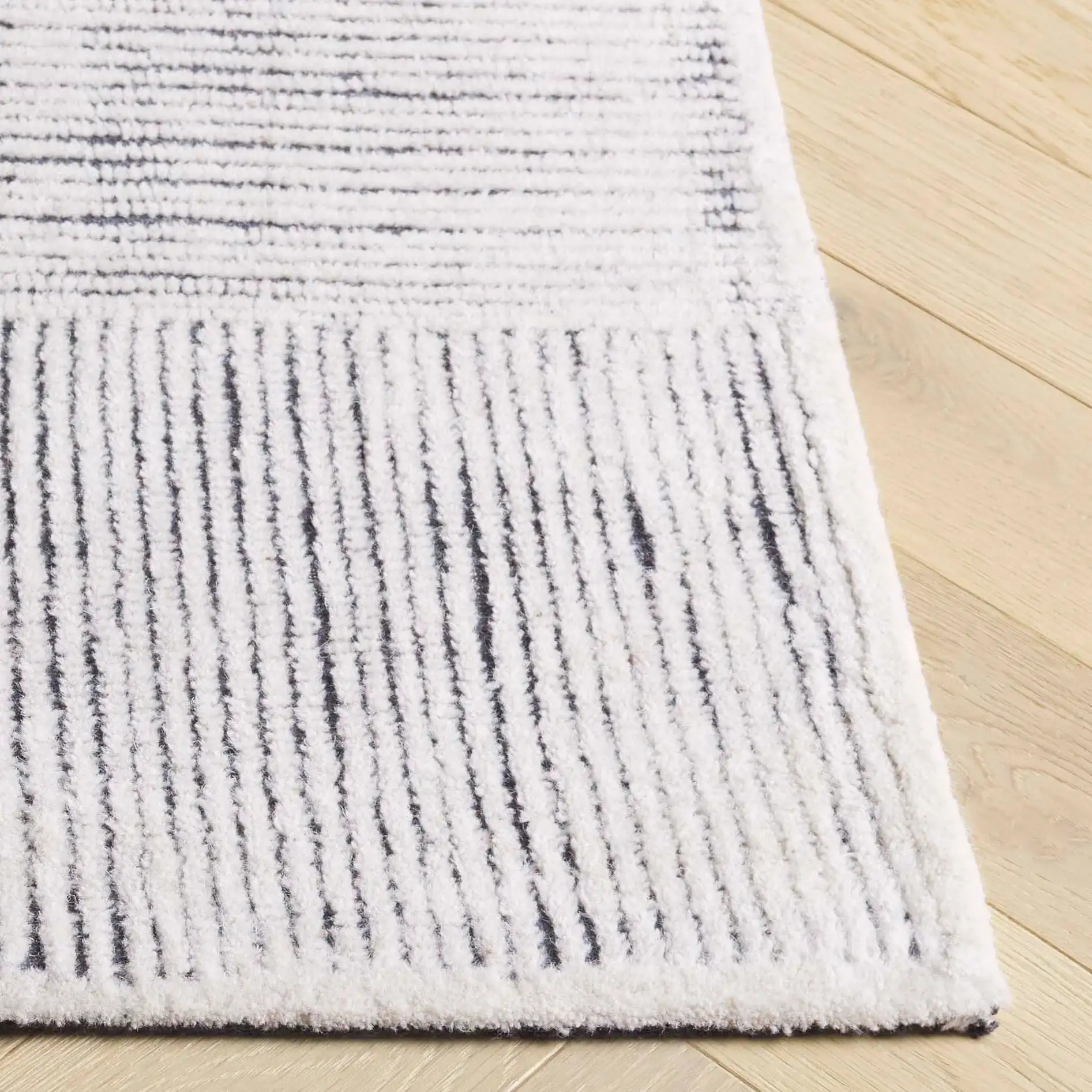 Metro Modern Checkerboard Hand-Tufted Wool Rug in Ivory / Charcoal in a styled room