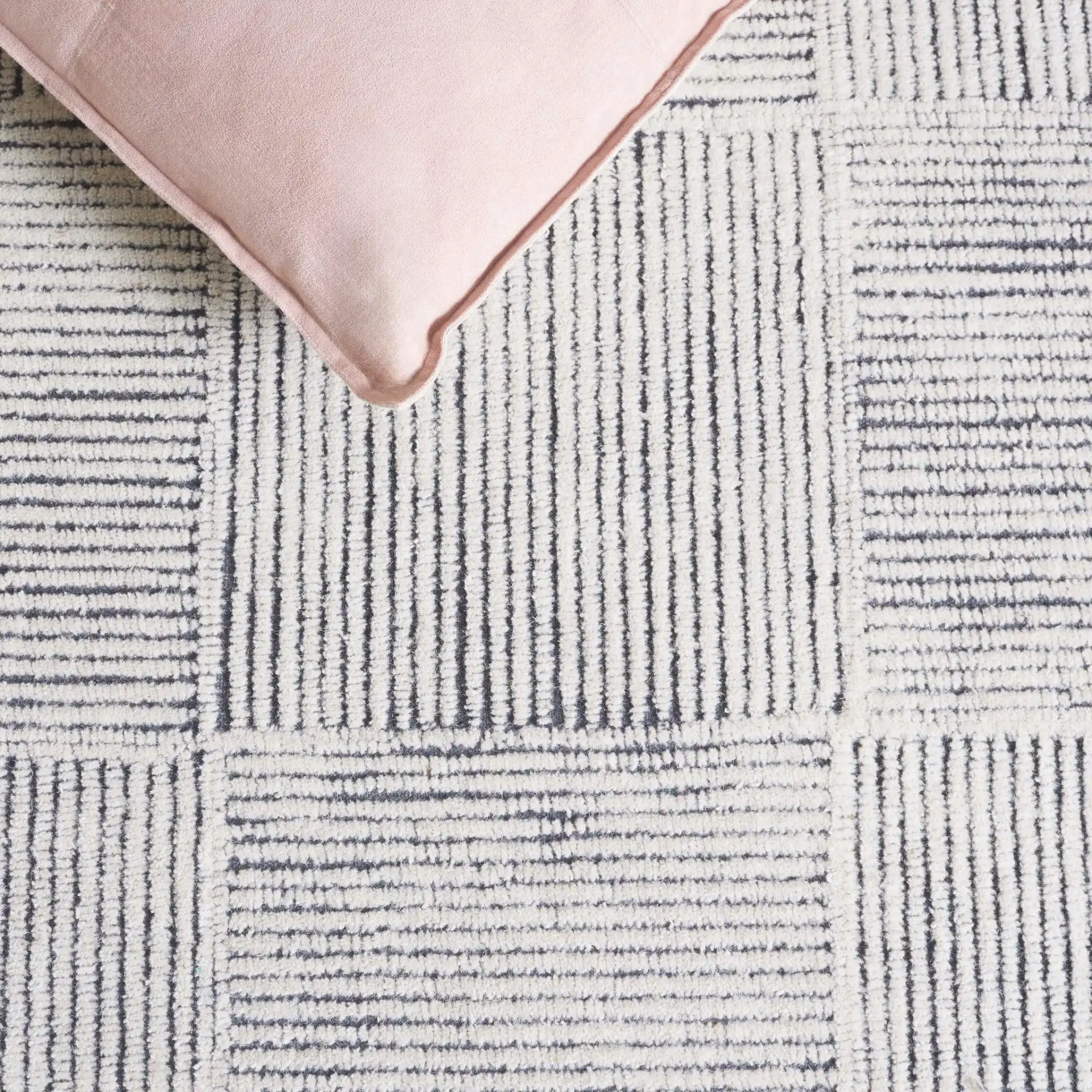 Metro Modern Checkerboard Hand-Tufted Wool Rug in Ivory / Charcoal in a styled room