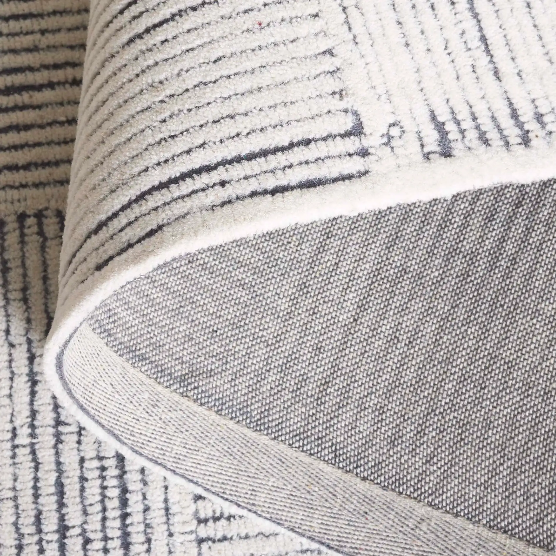 Metro Modern Checkerboard Hand-Tufted Wool Rug in Ivory / Charcoal in a styled room