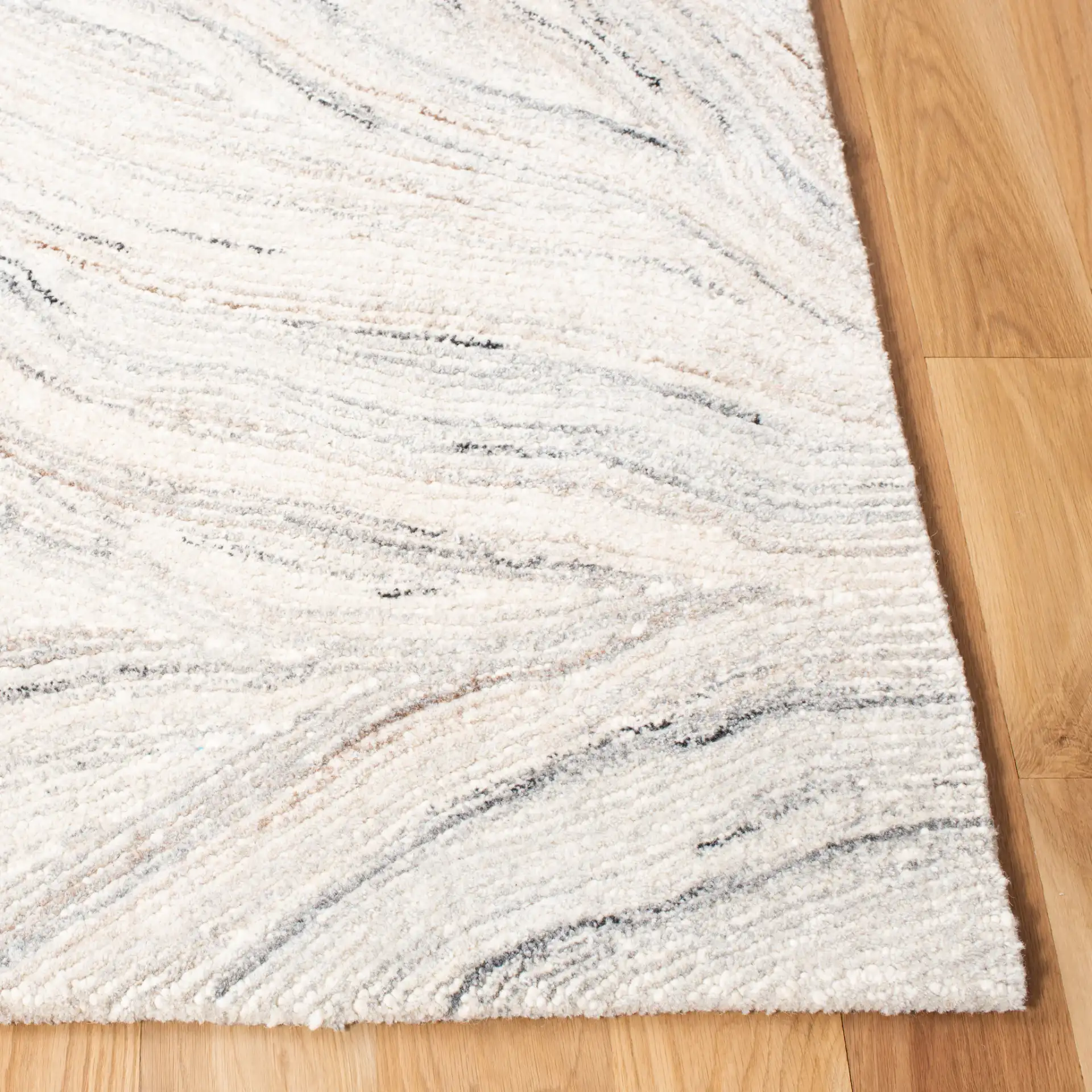 Metro Wavy Line Hand-Tufted Wool Rug in Ivory / Gray in a styled room