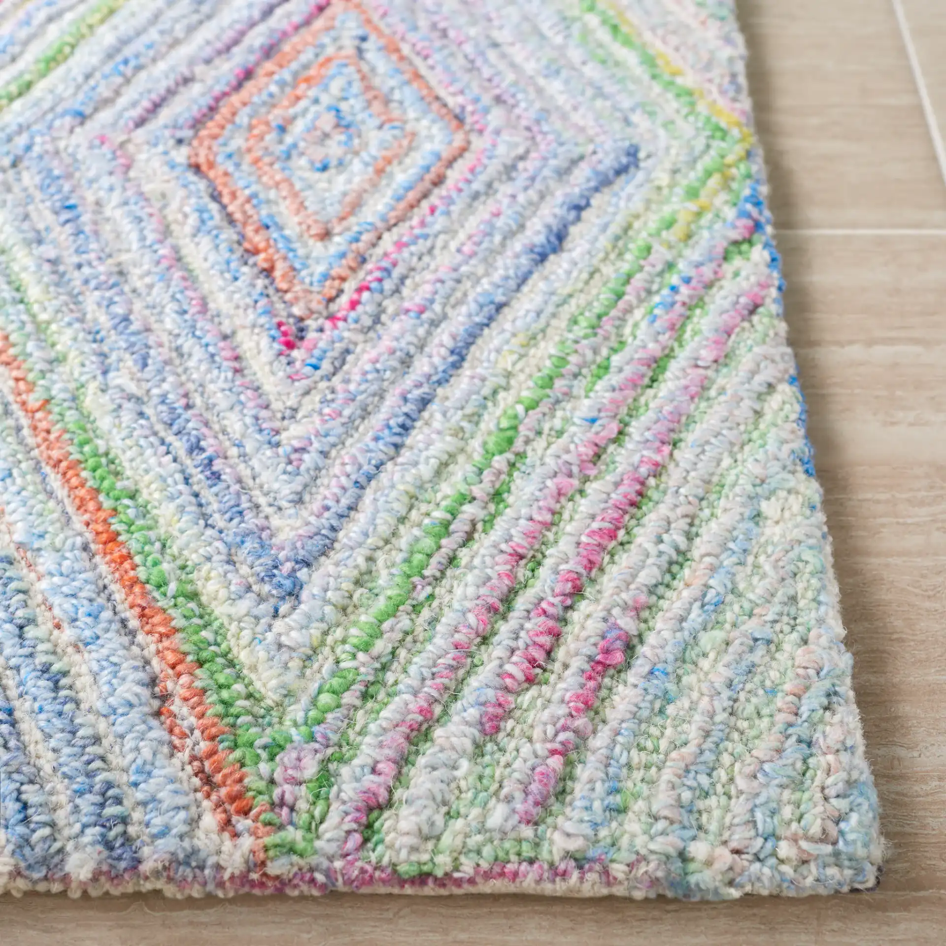 Metro Concentric Diamond Hand-Tufted Rug in Blue / Green in a styled room