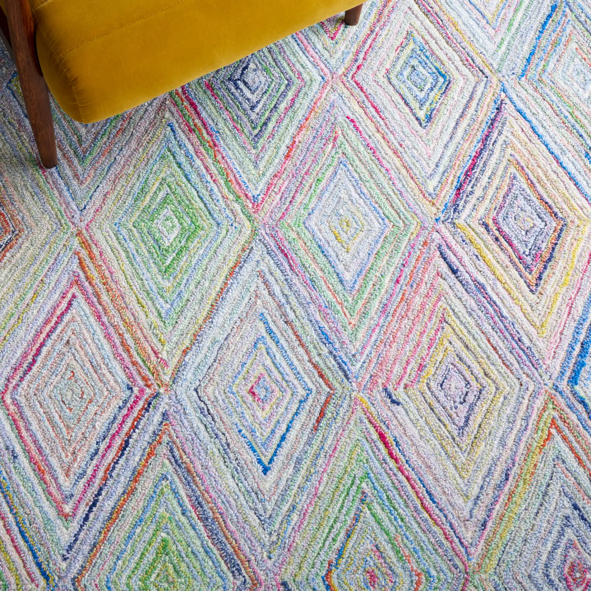 Metro Concentric Diamond Hand-Tufted Rug in Blue / Green in a styled room