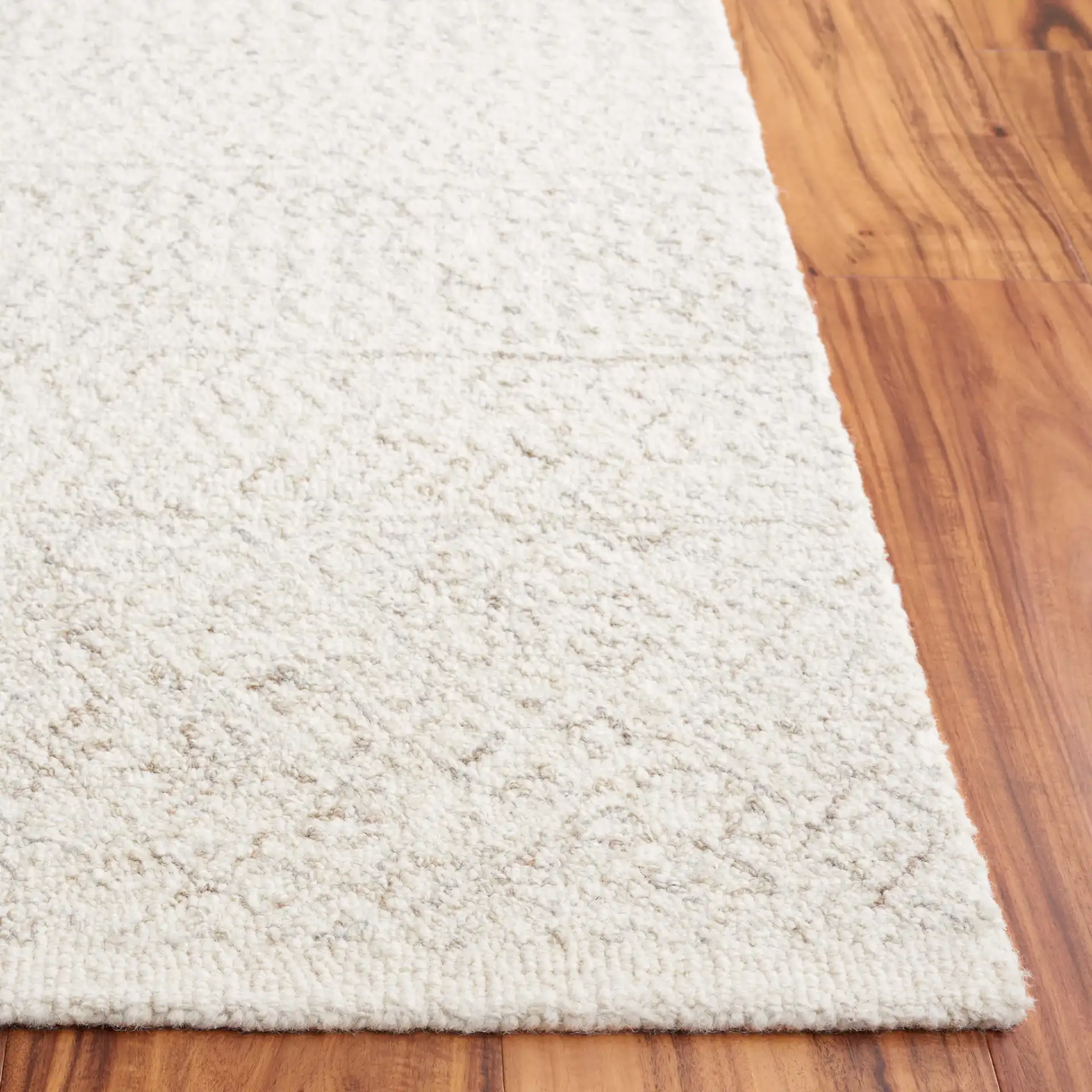 Metro Chevron Stripe Hand-Tufted Wool Rug in Ivory in a styled room