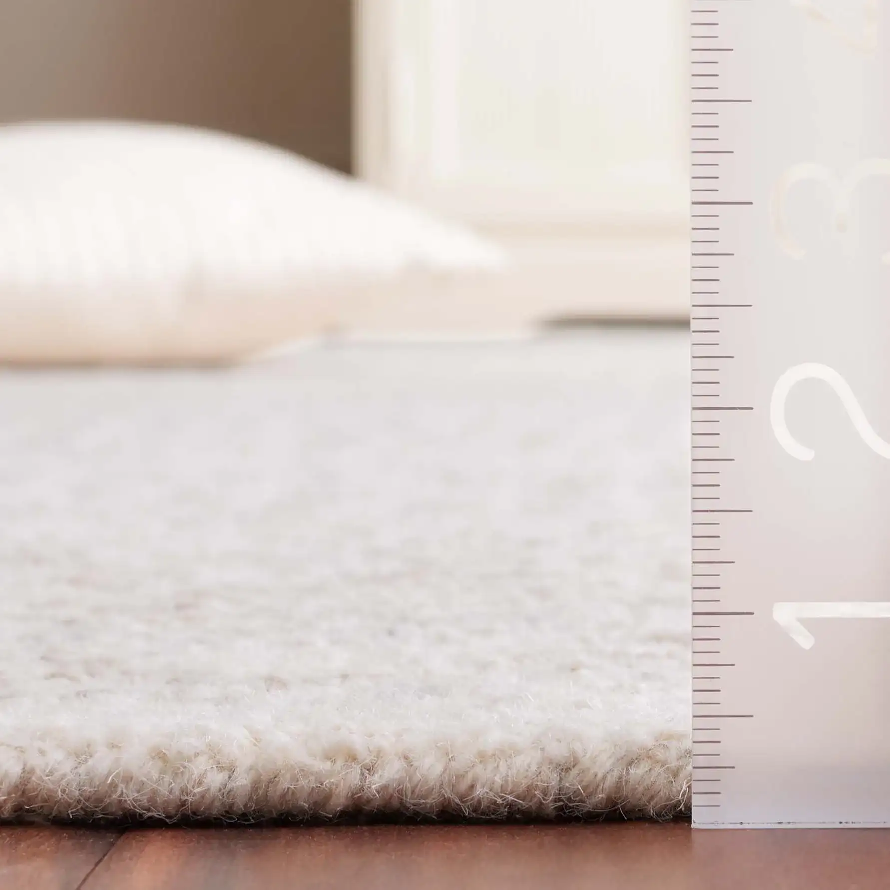 Metro Chevron Stripe Hand-Tufted Wool Rug in Ivory in a styled room