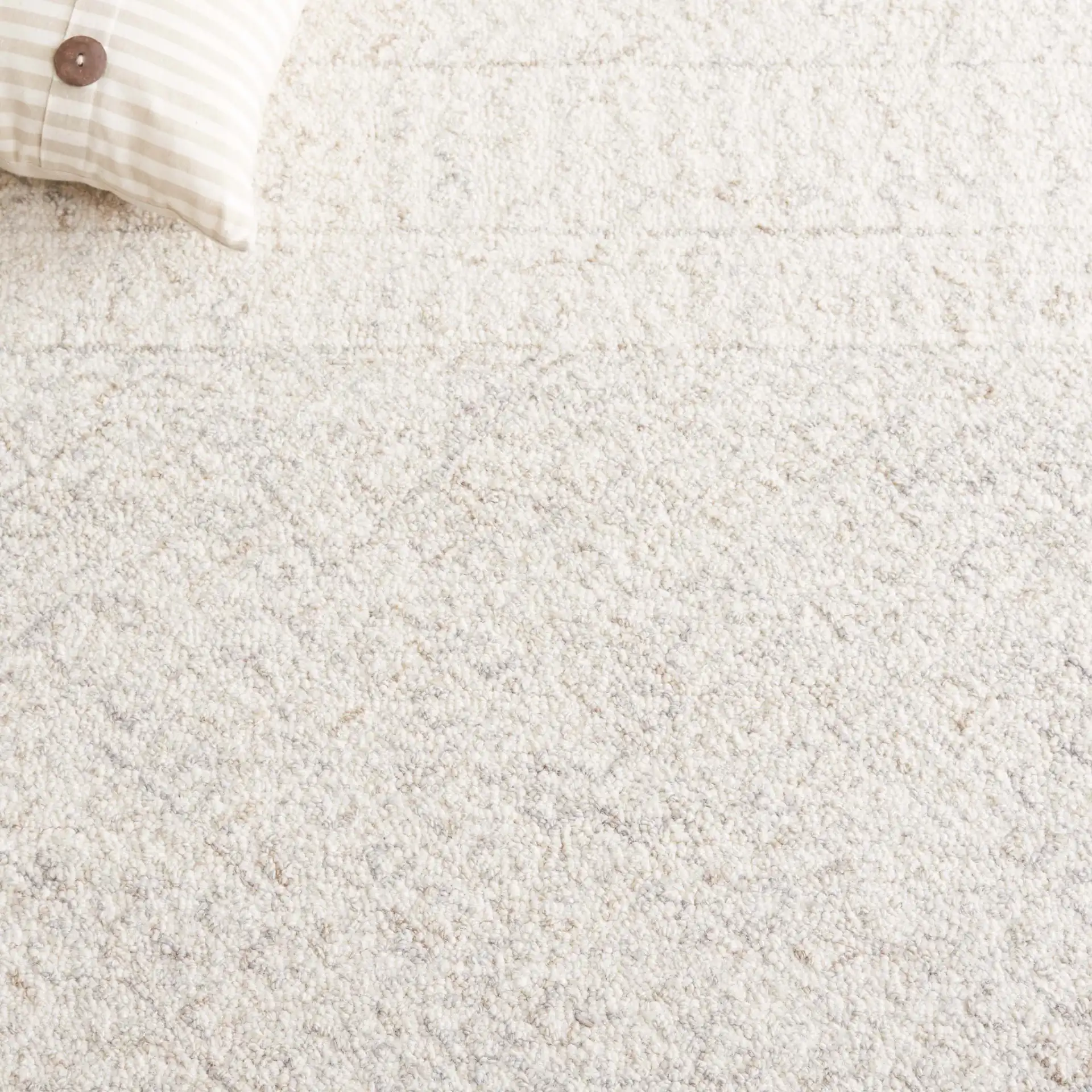 Metro Chevron Stripe Hand-Tufted Wool Rug in Ivory in a styled room