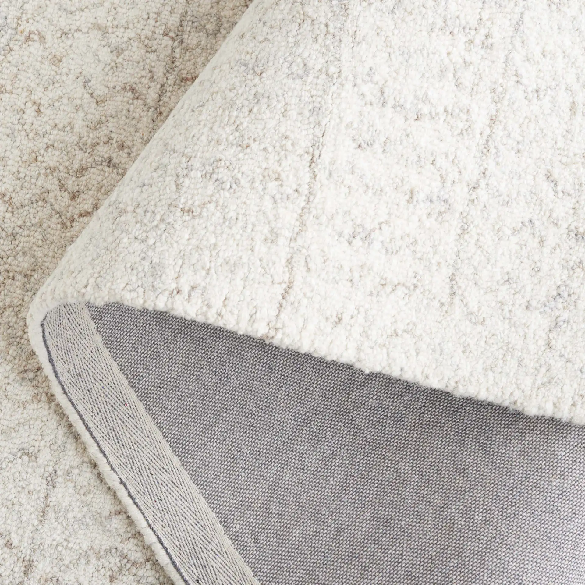 Metro Chevron Stripe Hand-Tufted Wool Rug in Ivory in a styled room
