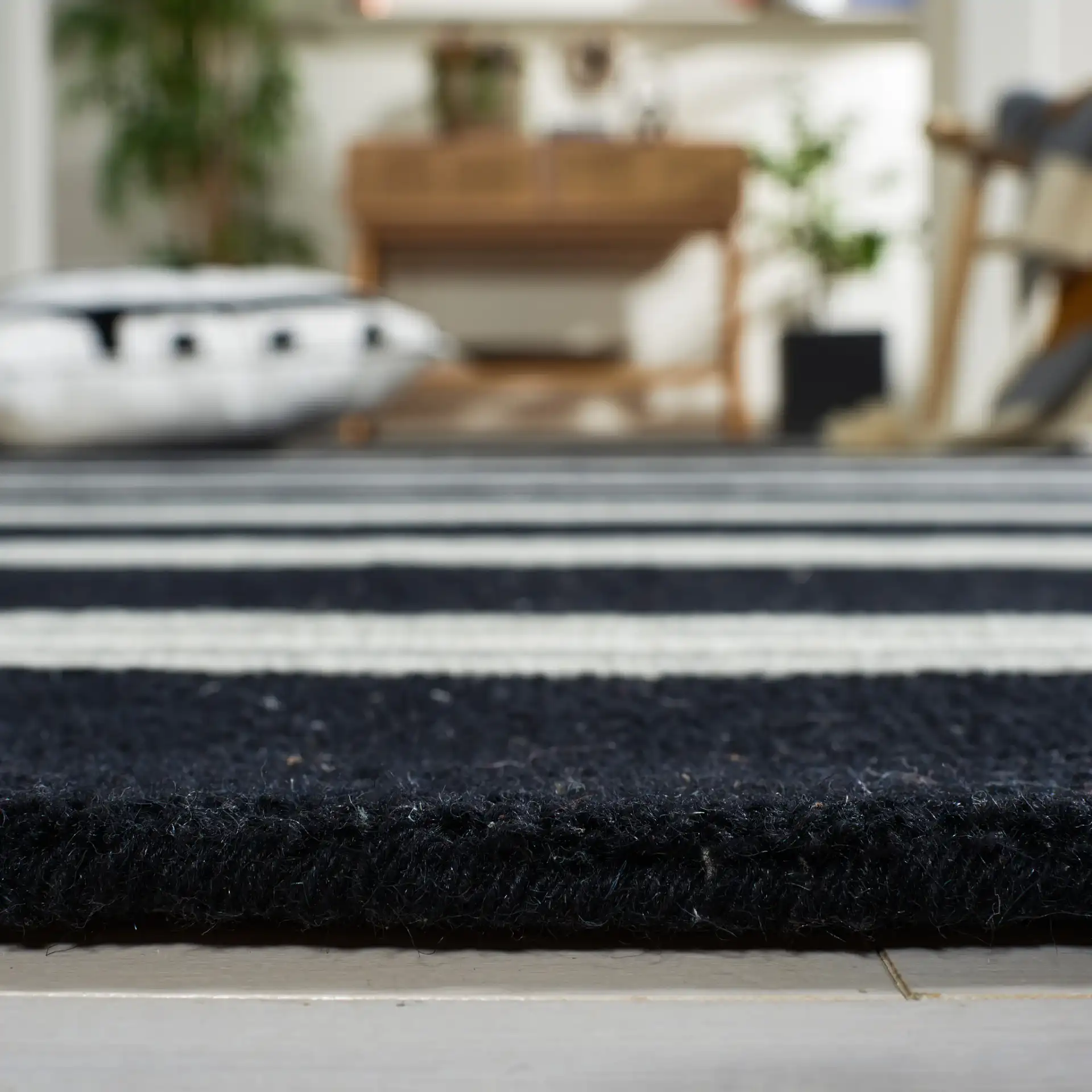Metro Striped Hand-Tufted Wool Rug in Black / Ivory in a styled room
