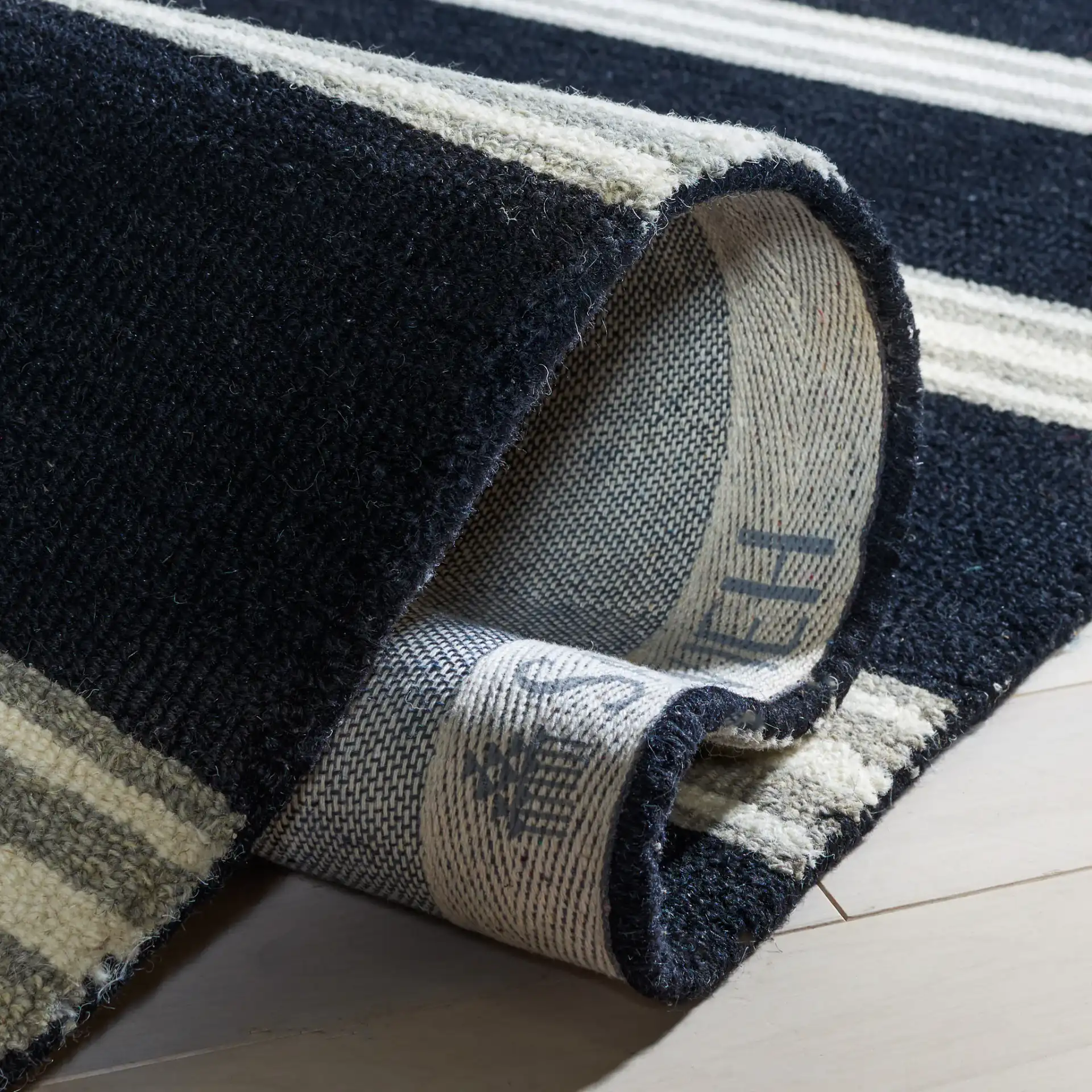Metro Striped Hand-Tufted Wool Rug in Black / Ivory in a styled room