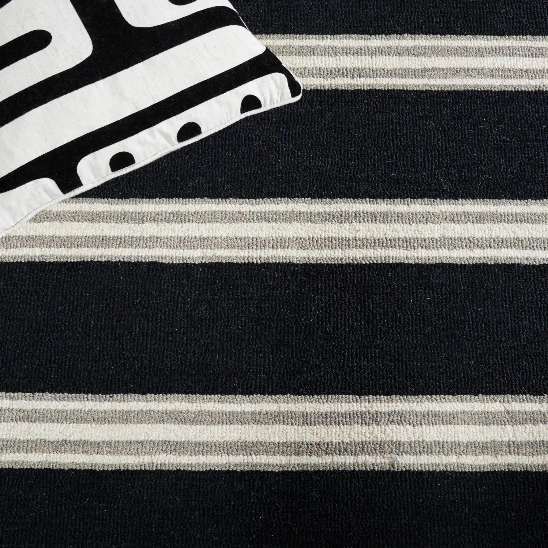 Metro Striped Hand-Tufted Wool Rug in Black / Ivory in a styled room