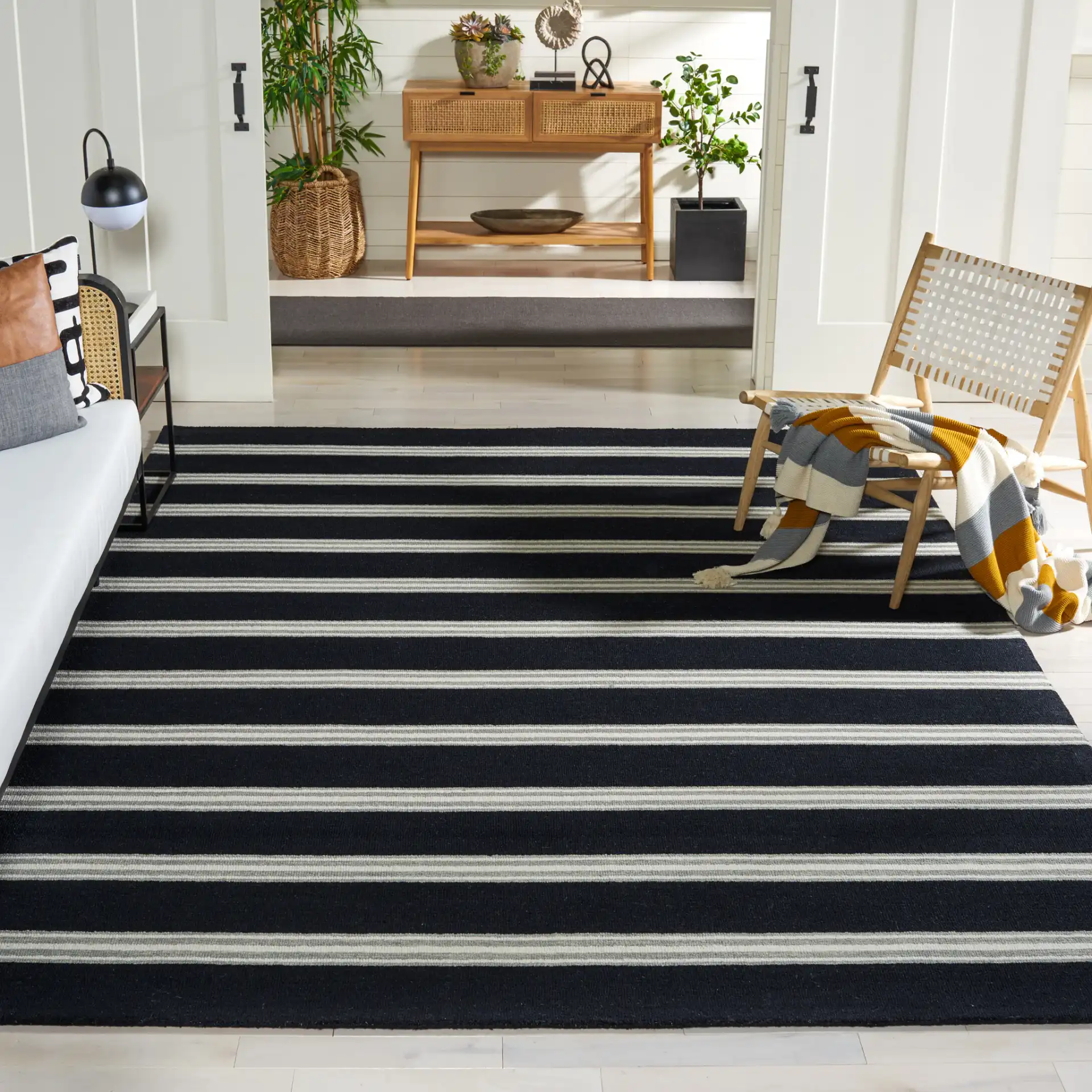 Metro Striped Hand-Tufted Wool Rug in Black / Ivory in a styled room