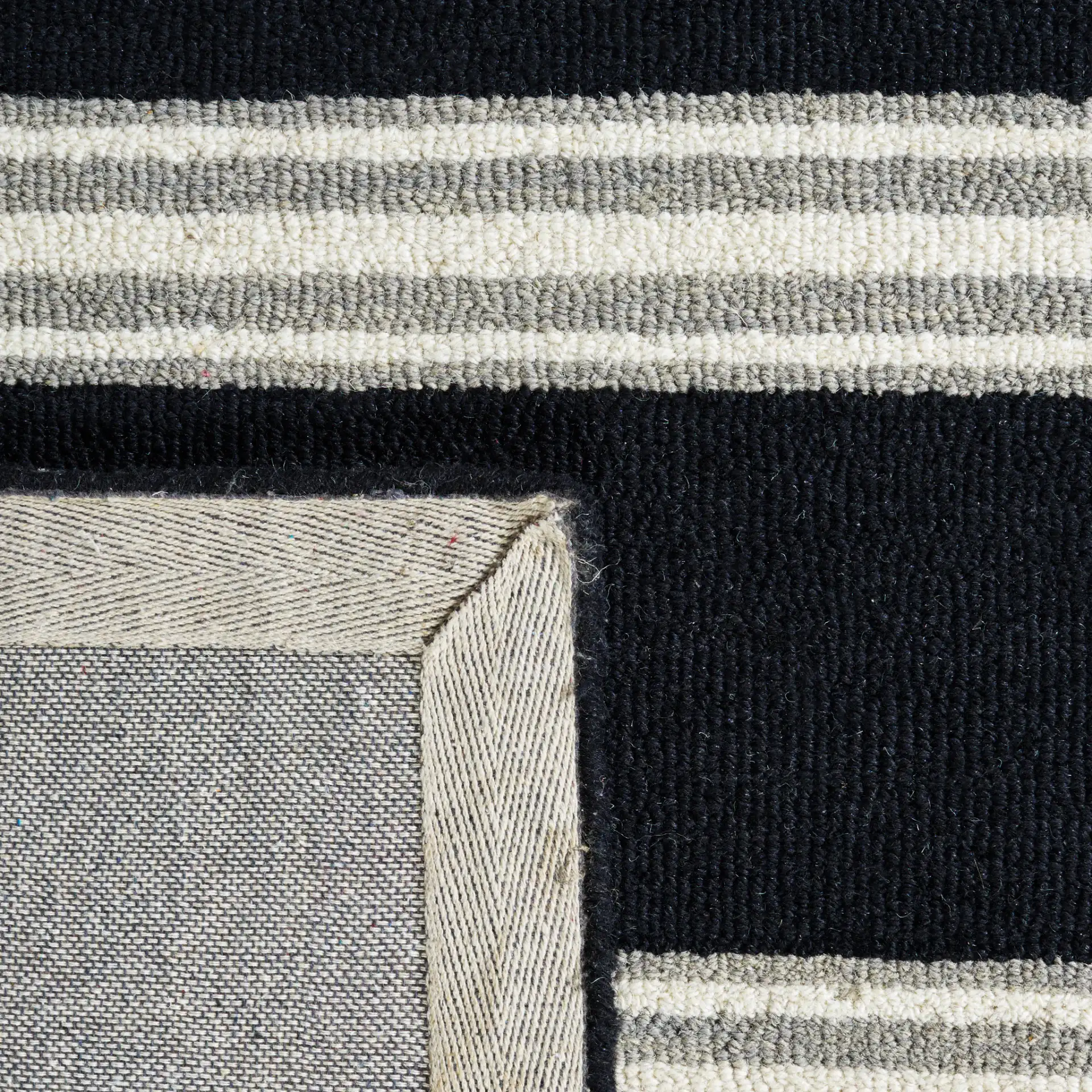 Metro Striped Hand-Tufted Wool Rug in Black / Ivory in a styled room