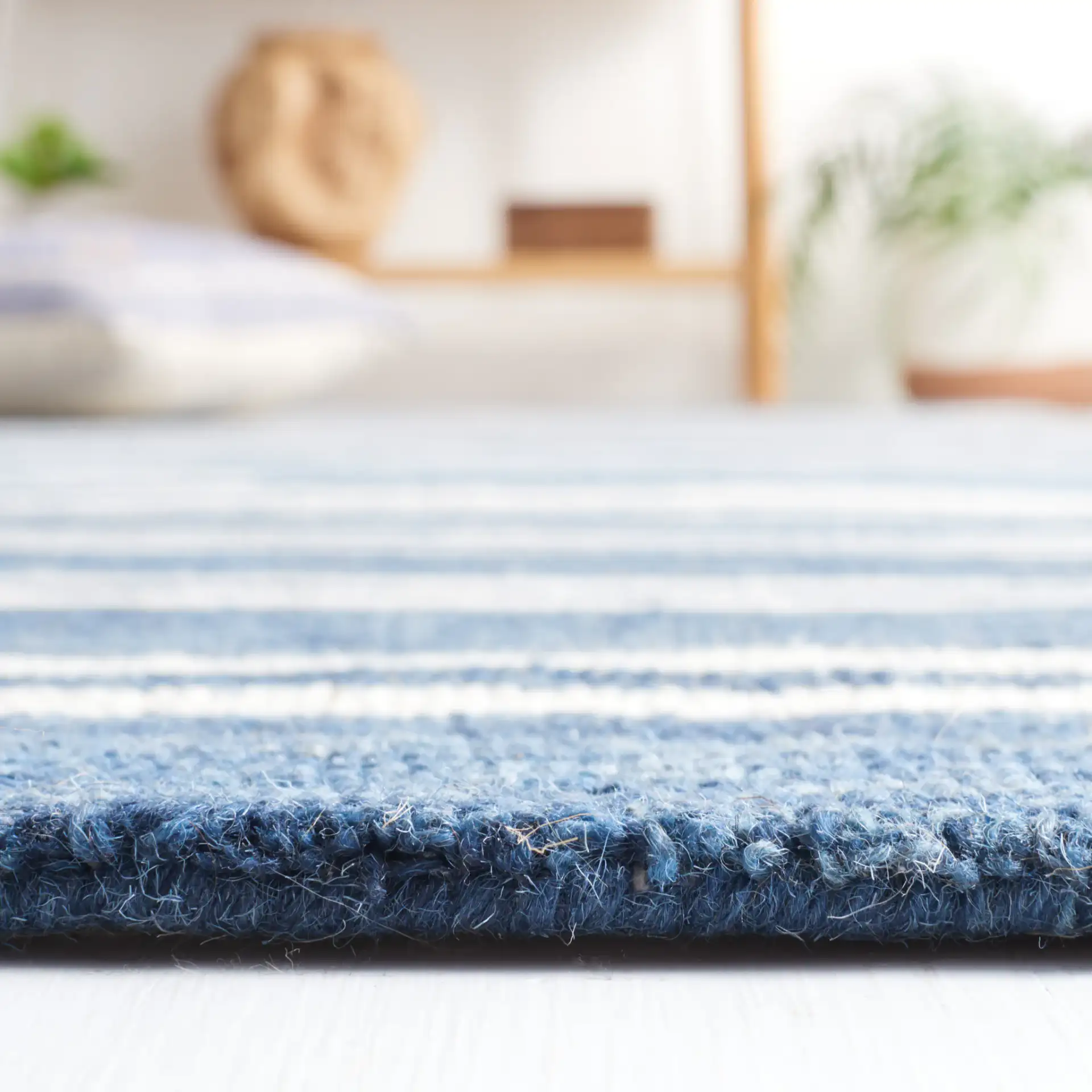 Metro Stripe Hand-Tufted Rug in Blue / Ivory in a styled room