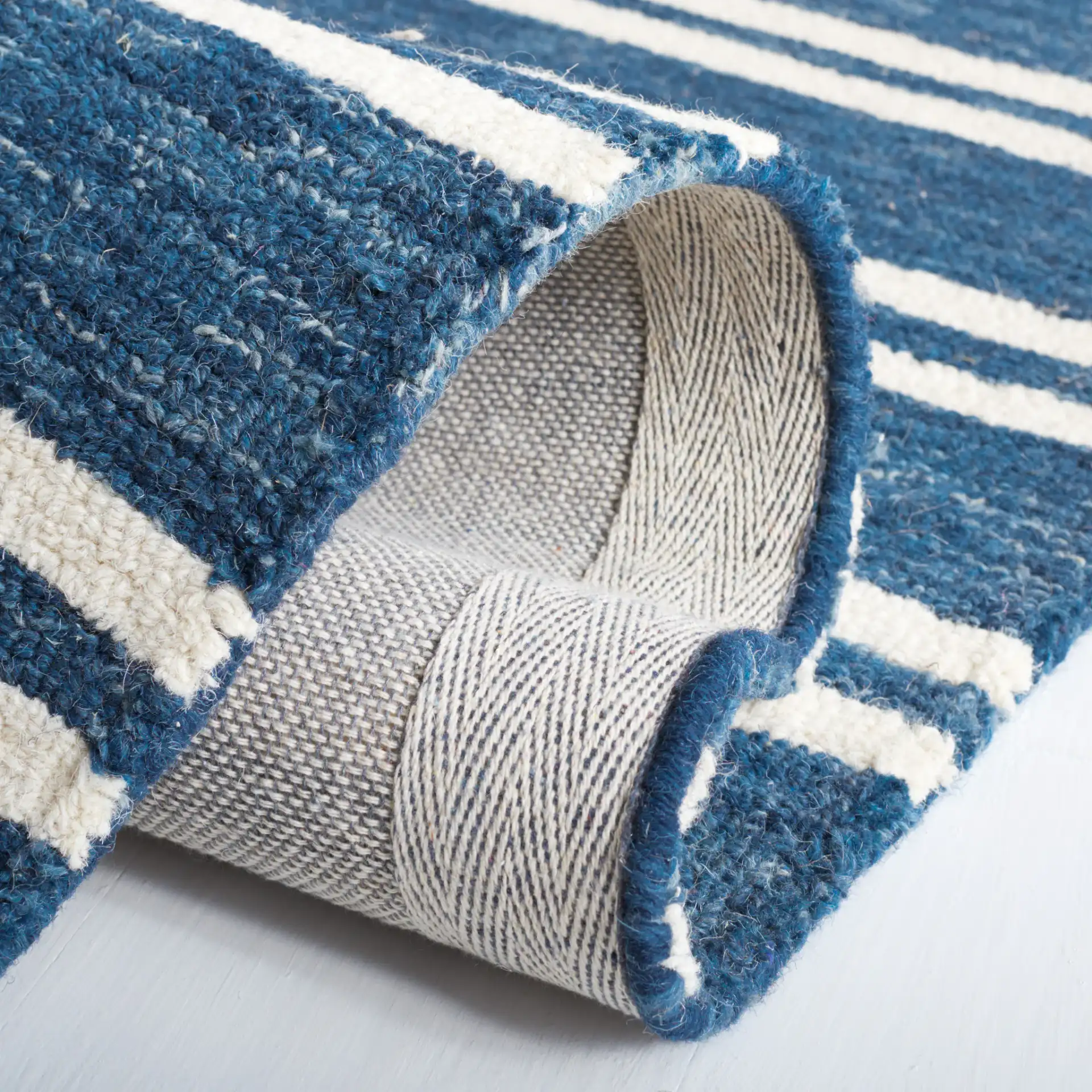 Metro Stripe Hand-Tufted Rug in Blue / Ivory in a styled room
