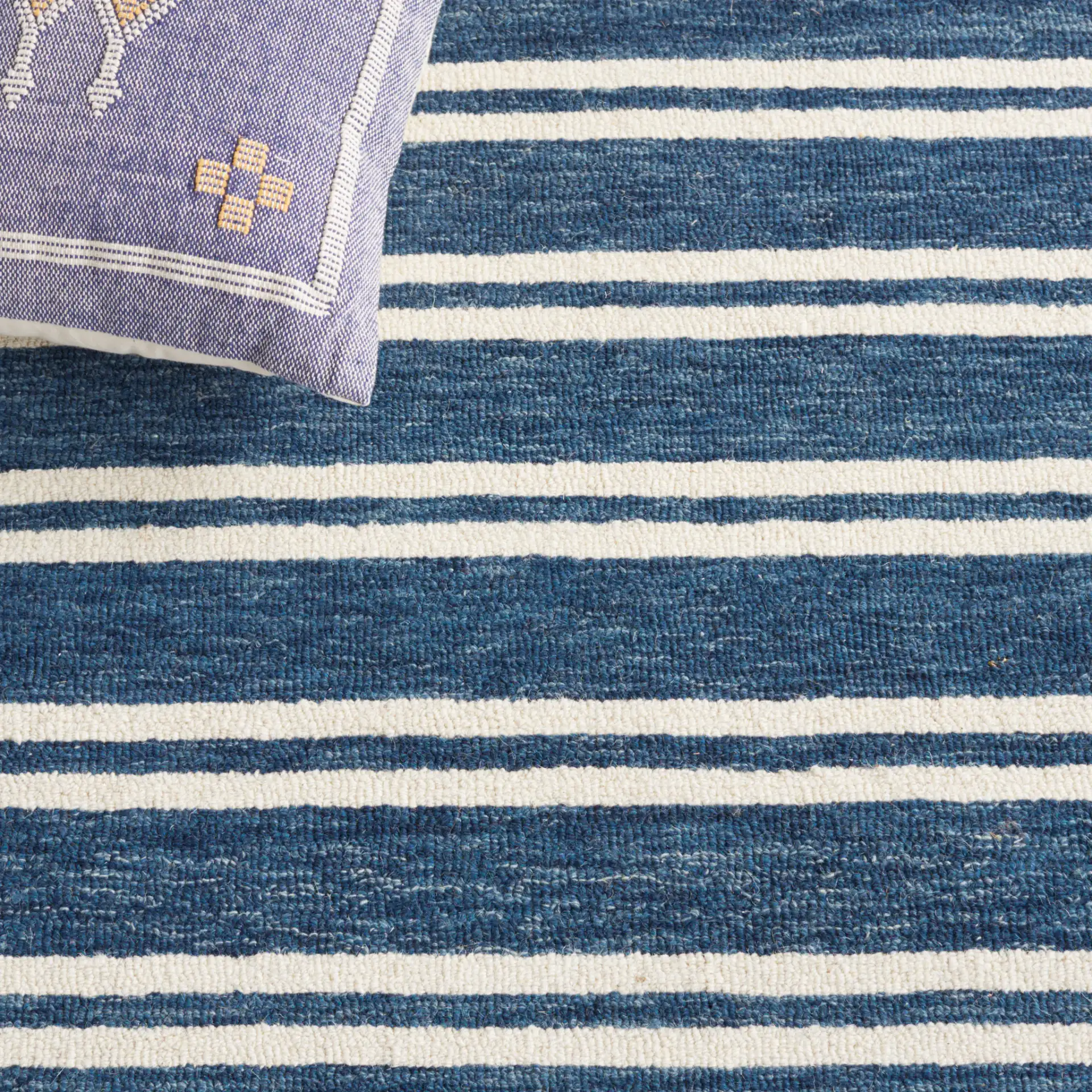 Metro Stripe Hand-Tufted Rug in Blue / Ivory in a styled room